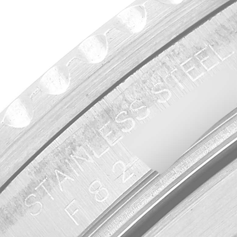 This image shows a close-up of the stainless steel bezel and engraved markings of a Rolex Submariner 16610 Men's Stainless Steel Black Dial 16610 Men's Stainless Steel Black Dial watch.