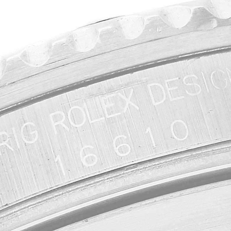 This close-up image shows the engraved model number and part of the bezel of a Rolex Submariner 16610 Men
s Stainless Steel Black Dial 16610 Men
s Stainless Steel Black Dial.