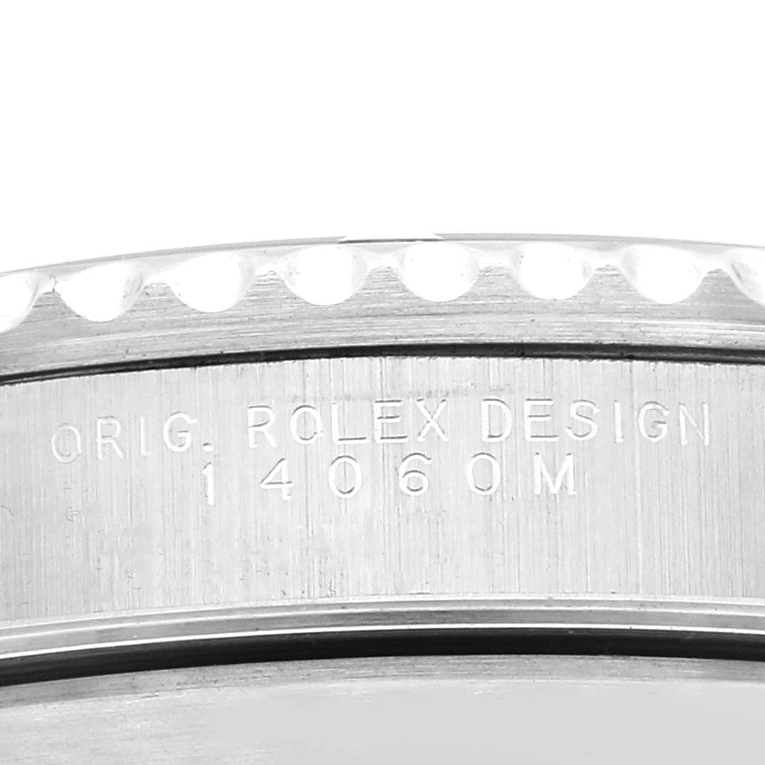 The image shows a close-up view of the bezel and case back of a Rolex Submariner 14060M Men
s Stainless Steel Black Dial 14060M Men
s Stainless Steel Black Dial, displaying the model number 14060M.