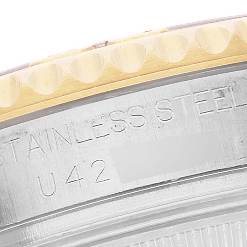 This close-up image shows the bezel and part of the caseback of the Rolex Yacht-Master 68623 Men
s Steel and Gold (two tone) Grey Dial 68623 Men
s Steel and Gold (two tone) Grey Dial watch, featuring "STAINLESS STEEL" engraving.