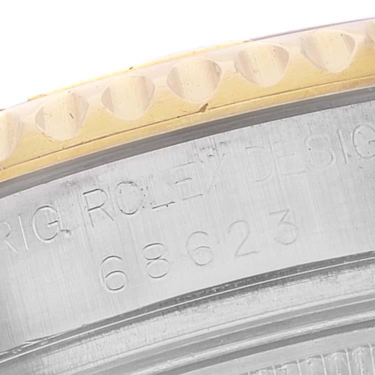 The image shows an angled close-up of the bezel and case side of a Rolex Yacht-Master 68623 Men
s Steel and Gold (two tone) Grey Dial 68623 Men
s Steel and Gold (two tone) Grey Dial, displaying parts of the engraved model number.