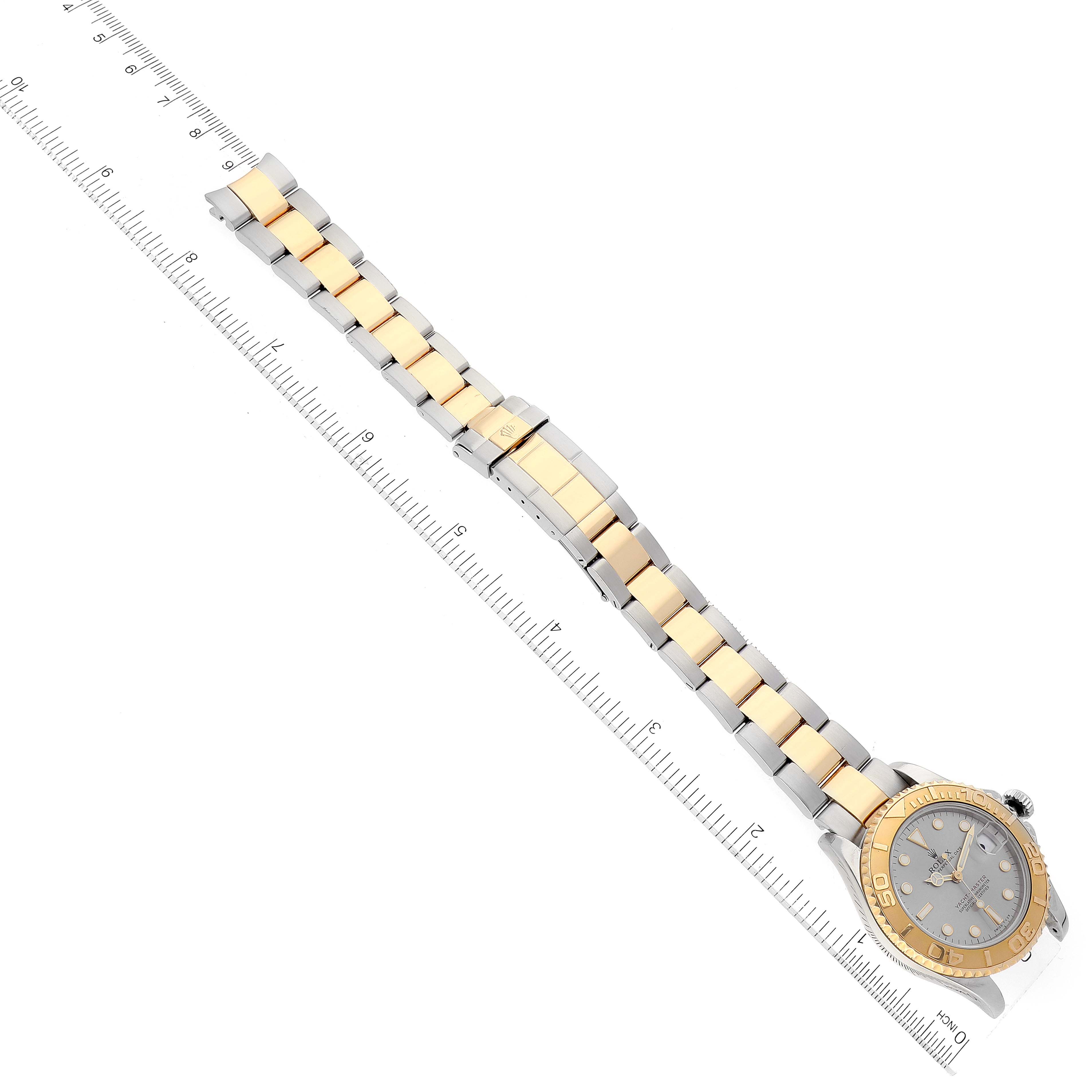 The image shows a full view of a Rolex Yacht-Master 68623 Men
s Steel and Gold (two tone) Grey Dial 68623 Men
s Steel and Gold (two tone) Grey Dial watch laid out flat with a ruler alongside for measurement.