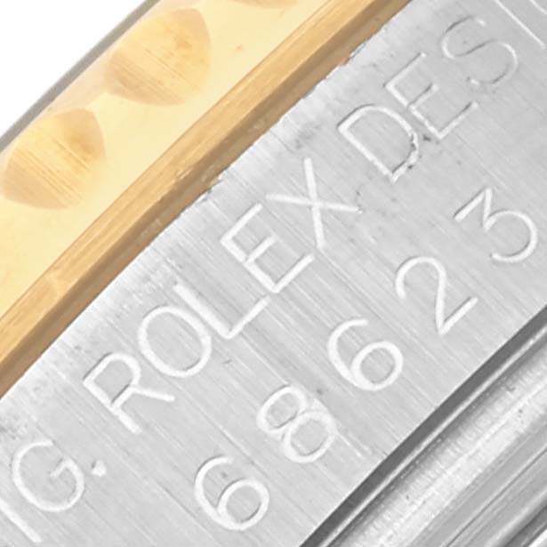 The image shows a close-up of the side of a Rolex Yacht-Master 68623 Men's Steel and Gold (two tone) Blue Dial 68623 Men's Steel and Gold (two tone) Blue Dial, focusing on the bezel and engraved text.