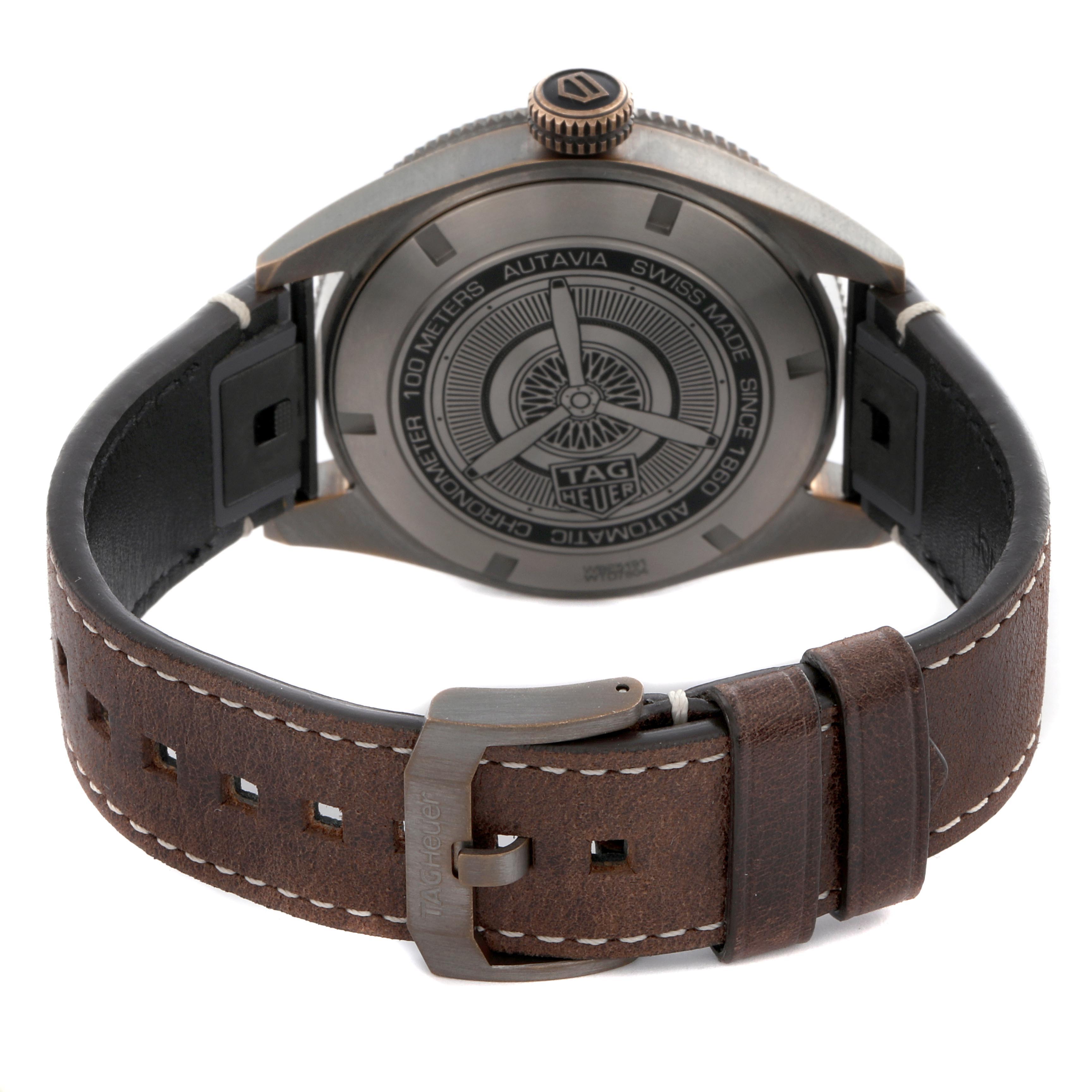 The image shows the back view of a Tag Heuer Autavia WBE5191.FC8276 Men's Bronze Brown Dial WBE5191.FC8276 Men's Bronze Brown Dial watch with its leather strap and engraved case back.
