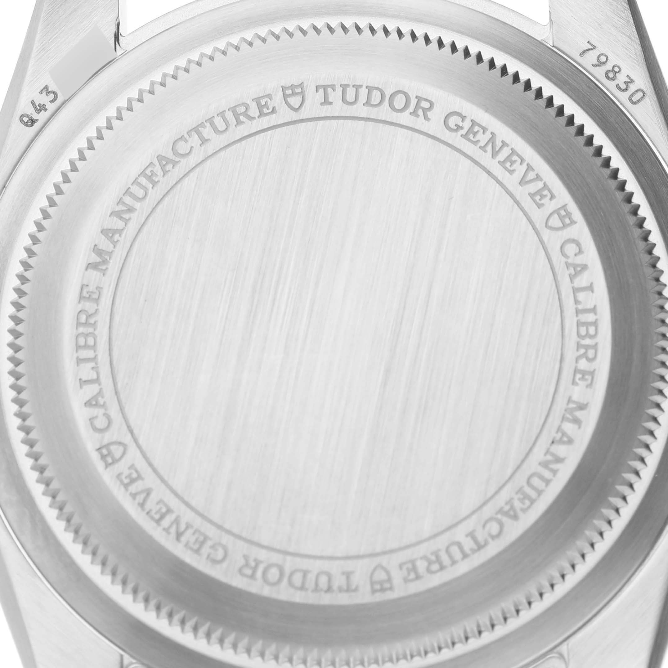 The image shows the case back of a Tudor Heritage Black Bay 79830RB Men's Stainless Steel Black Dial 79830RB Men's Stainless Steel Black Dial watch from a top-down angle, highlighting the engravings and notched edge.