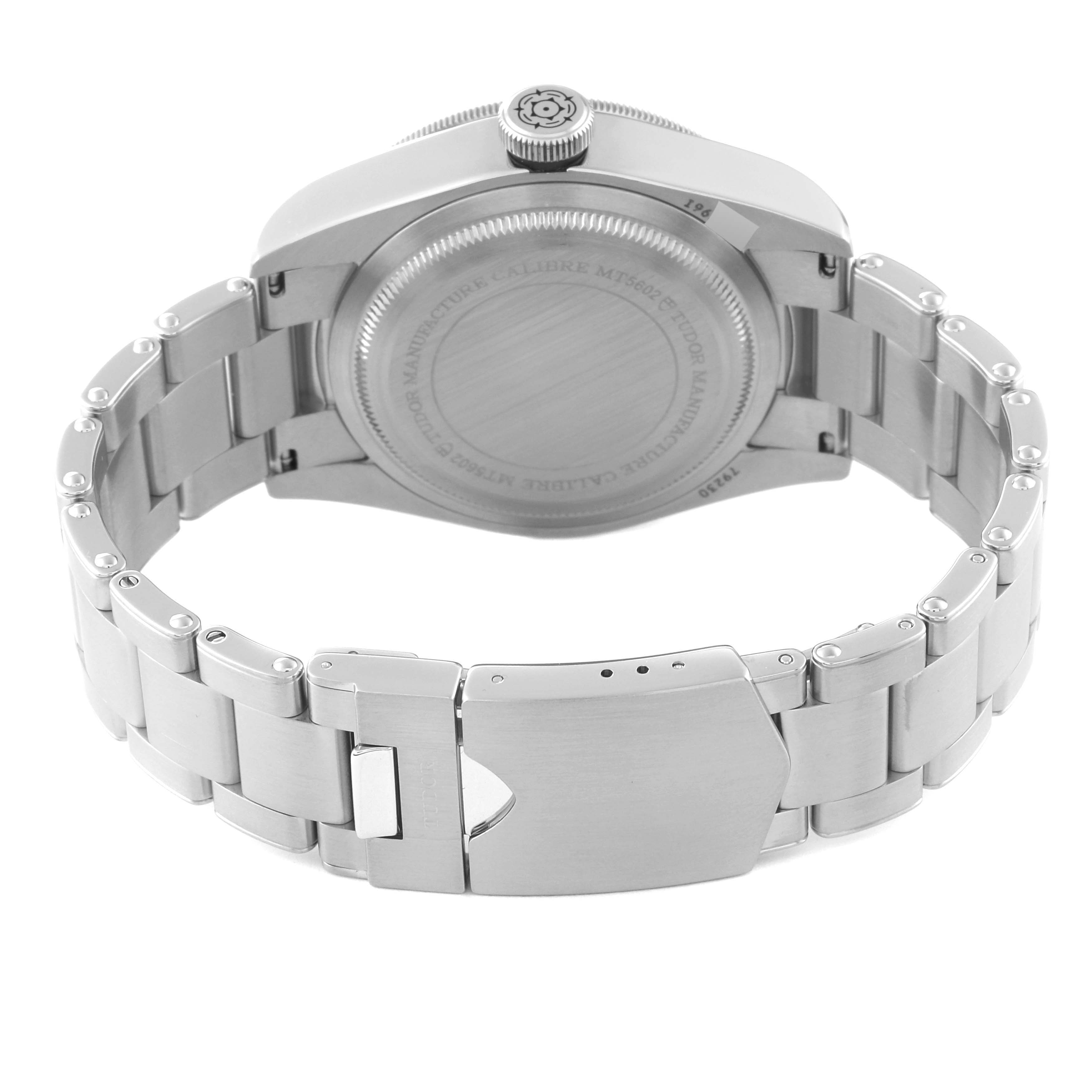 This image shows the back view of the Tudor Heritage Black Bay 79230R Men's Stainless Steel Black Dial 79230R Men's Stainless Steel Black Dial watch, showcasing its case back, crown, and metal bracelet with clasp.