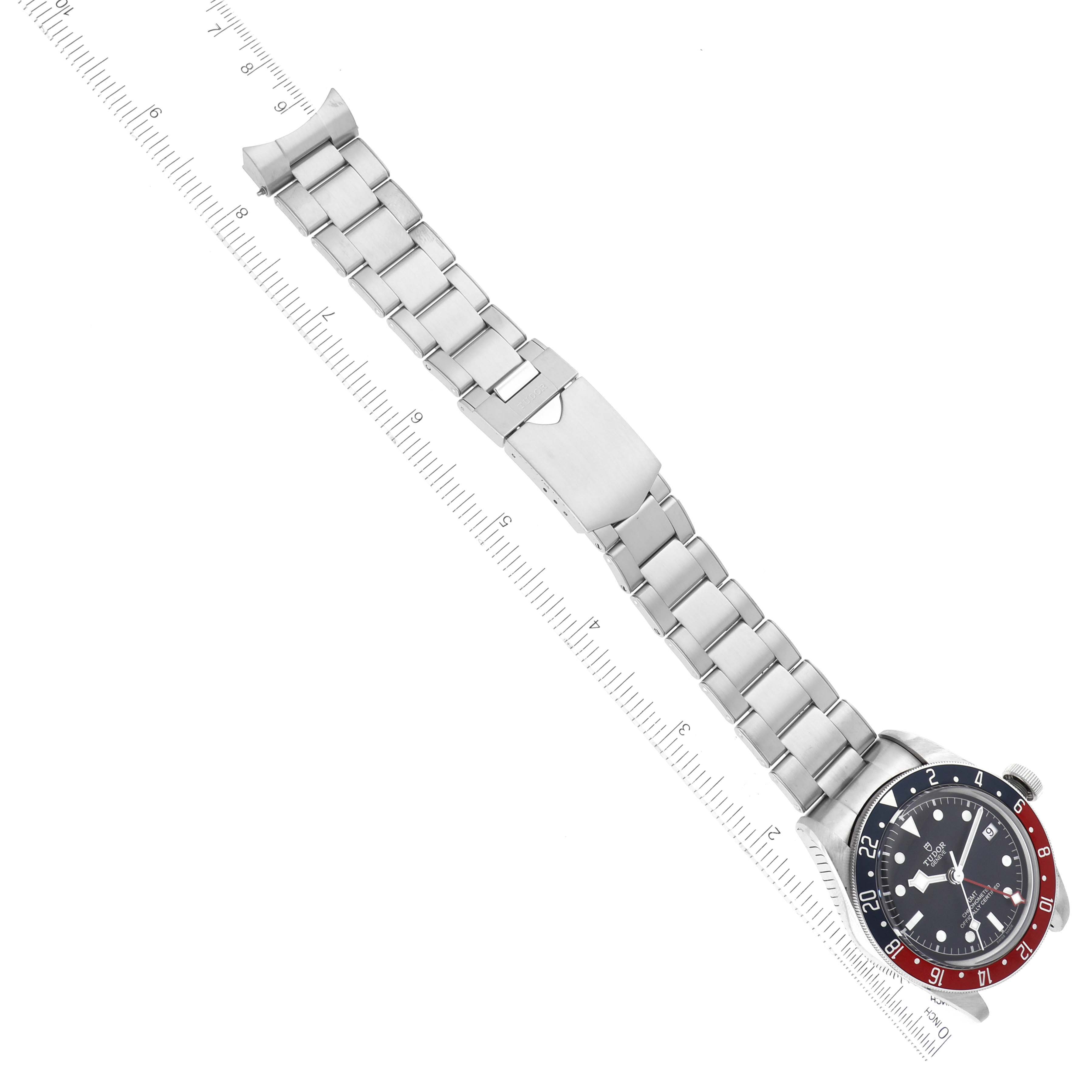 The image shows a Tudor Heritage Black Bay 79830RB Men's Stainless Steel Black Dial 79830RB Men's Stainless Steel Black Dial watch from an angled top-down perspective, featuring the face and metal bracelet with clasp extended.