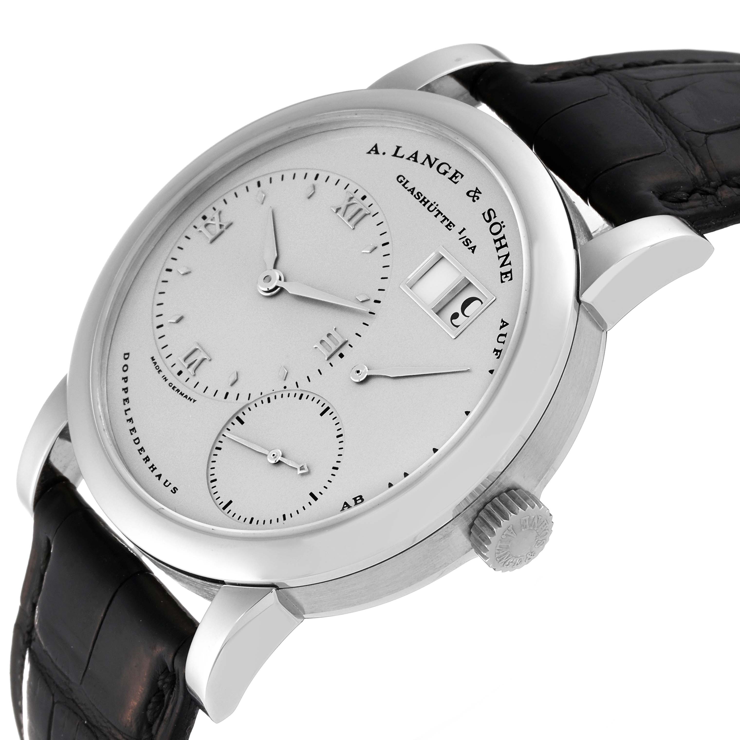 The image shows a close-up view of the A. Lange 
Sohne Lange 1 101.025 Men
s Platinum Silver Dial watch, highlighting the dial, crown, and leather strap.