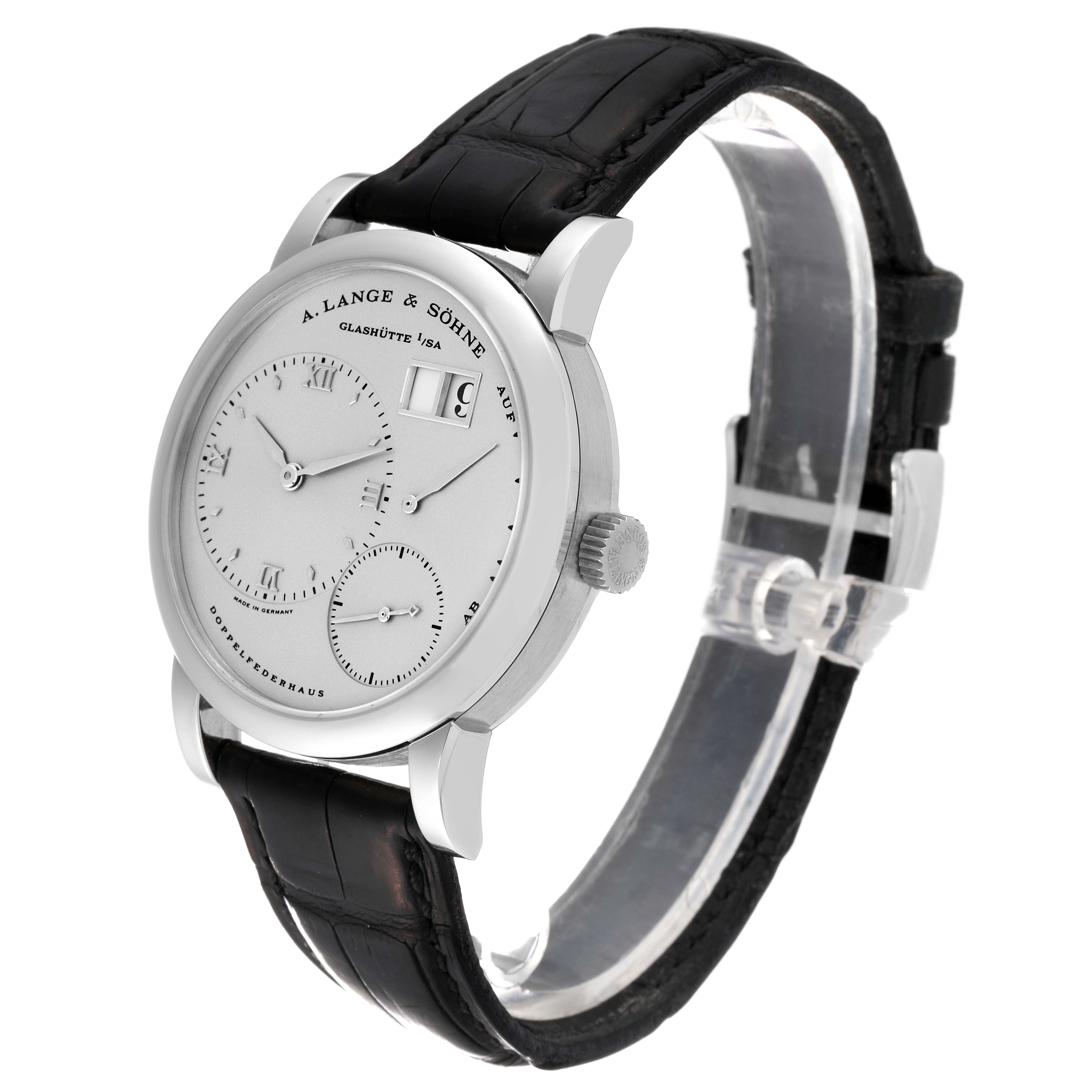 The image shows a side angle of the A. Lange 
Sohne Lange 1 101.025 Men
s Platinum Silver Dial watch, highlighting its dial, crown, and black leather strap.