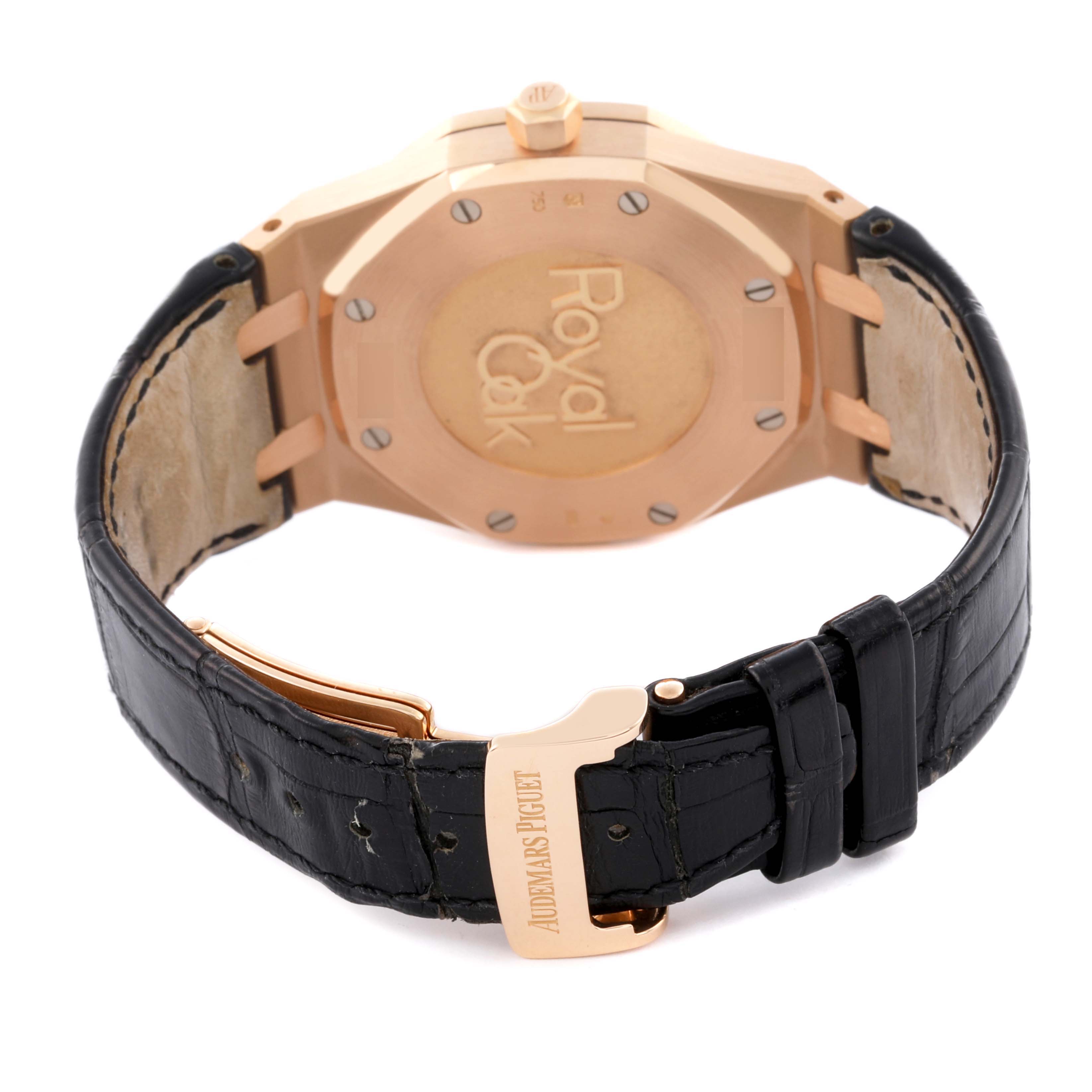 The image shows the back of the Audemars Piguet Royal Oak 26120OR.OO.D088CR.01 Men's Rose Gold Black Dial 26120OR.OO.D088CR.01 Men's Rose Gold Black Dial watch, highlighting the case back and leather strap with a clasp.