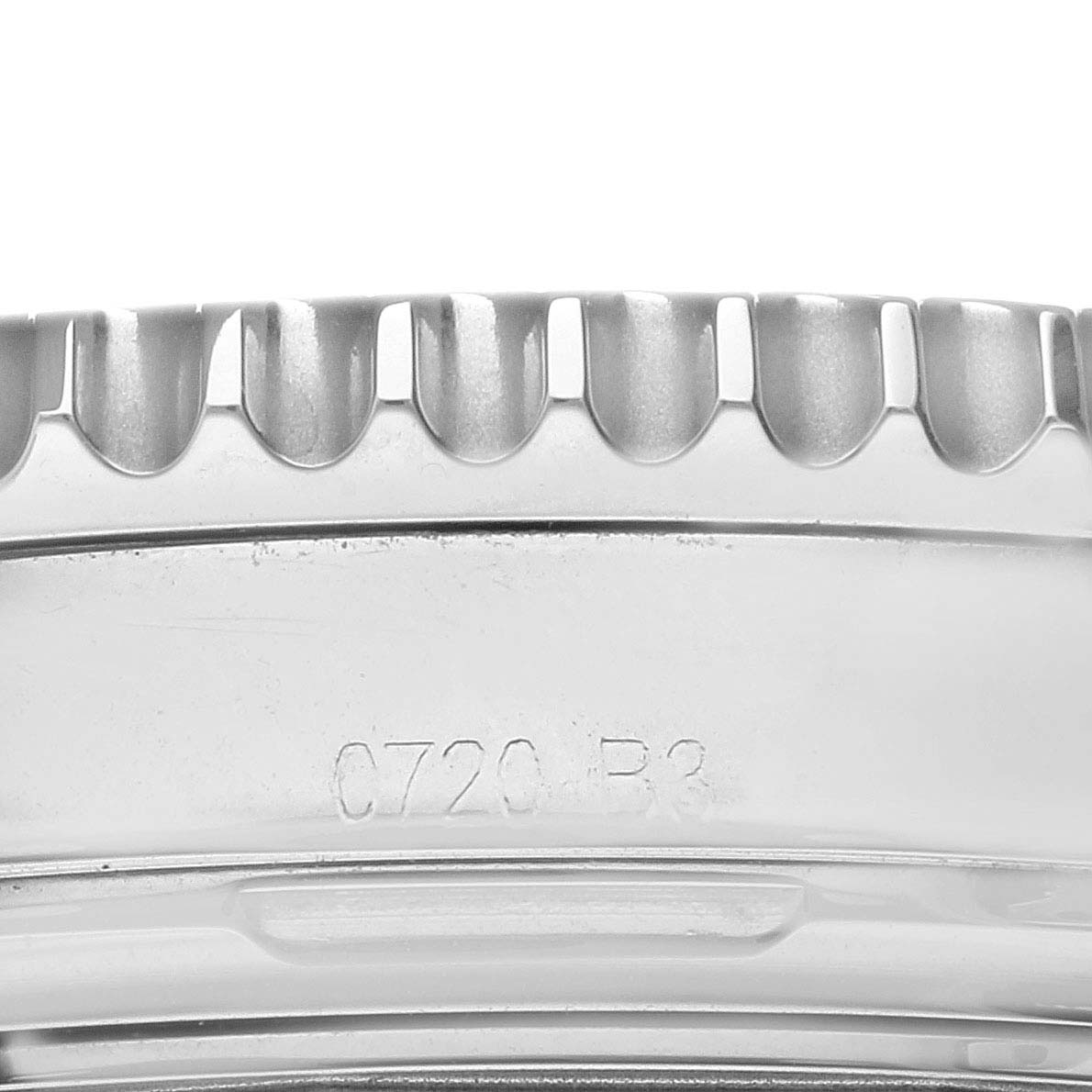 The image shows a close-up of the bezel and case of a Limited Series Breitling watch, highlighting the serial number and detailing.