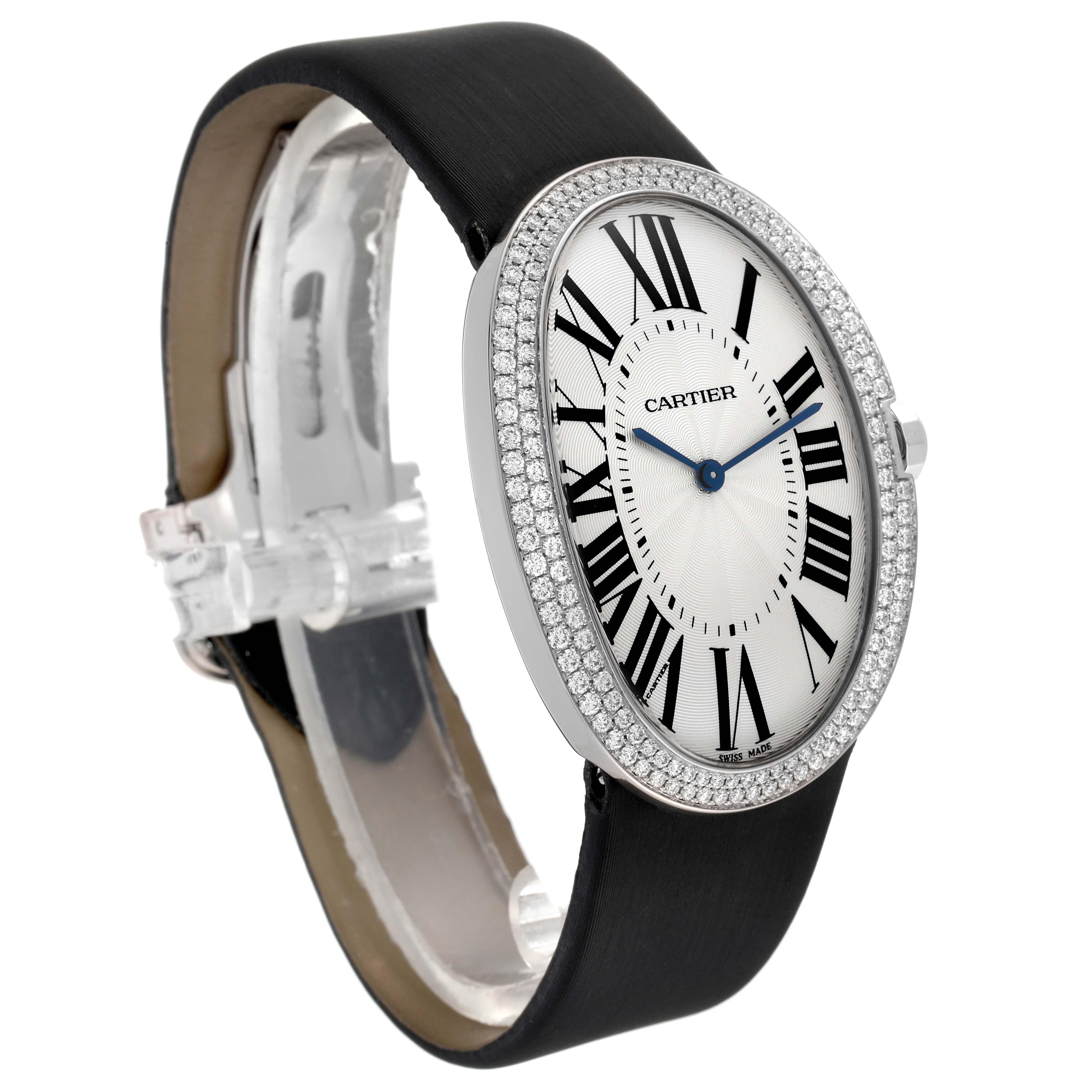 The Cartier Baignoire WB520009 Women's White Gold Silver Dial WB520009 Women's White Gold Silver Dial watch is shown from a front-side angle, displaying its oval dial, Roman numerals, diamond bezel, and leather strap.