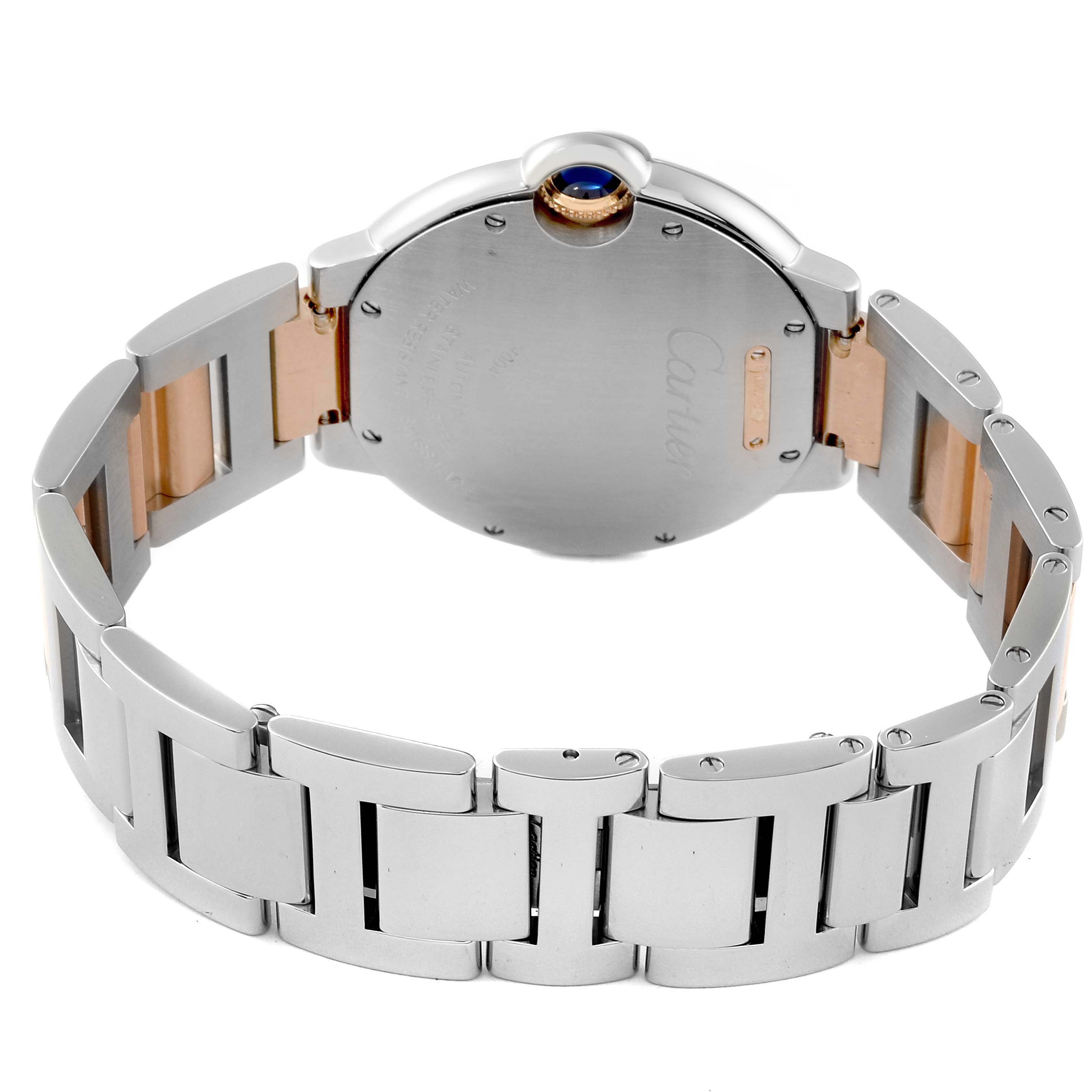 The image shows the back and part of the bracelet of a Ballon Bleu model by Cartier, highlighting the blue cabochon crown.