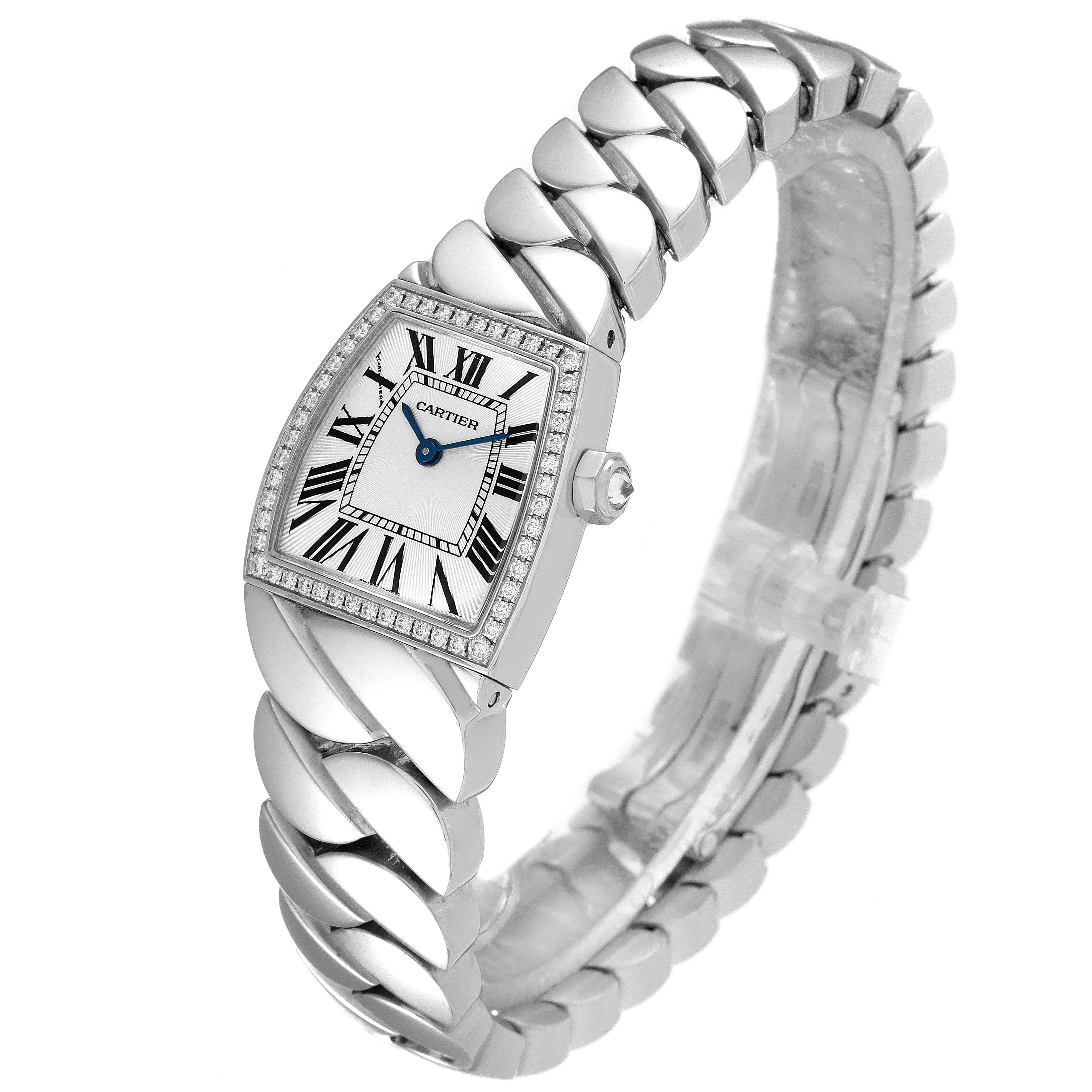 The Cartier La Dona WE601005 Women's White Gold Silver Dial WE601005 Women's White Gold Silver Dial watch is shown from a three-quarter angle, highlighting its face, bezel, and unique bracelet design.