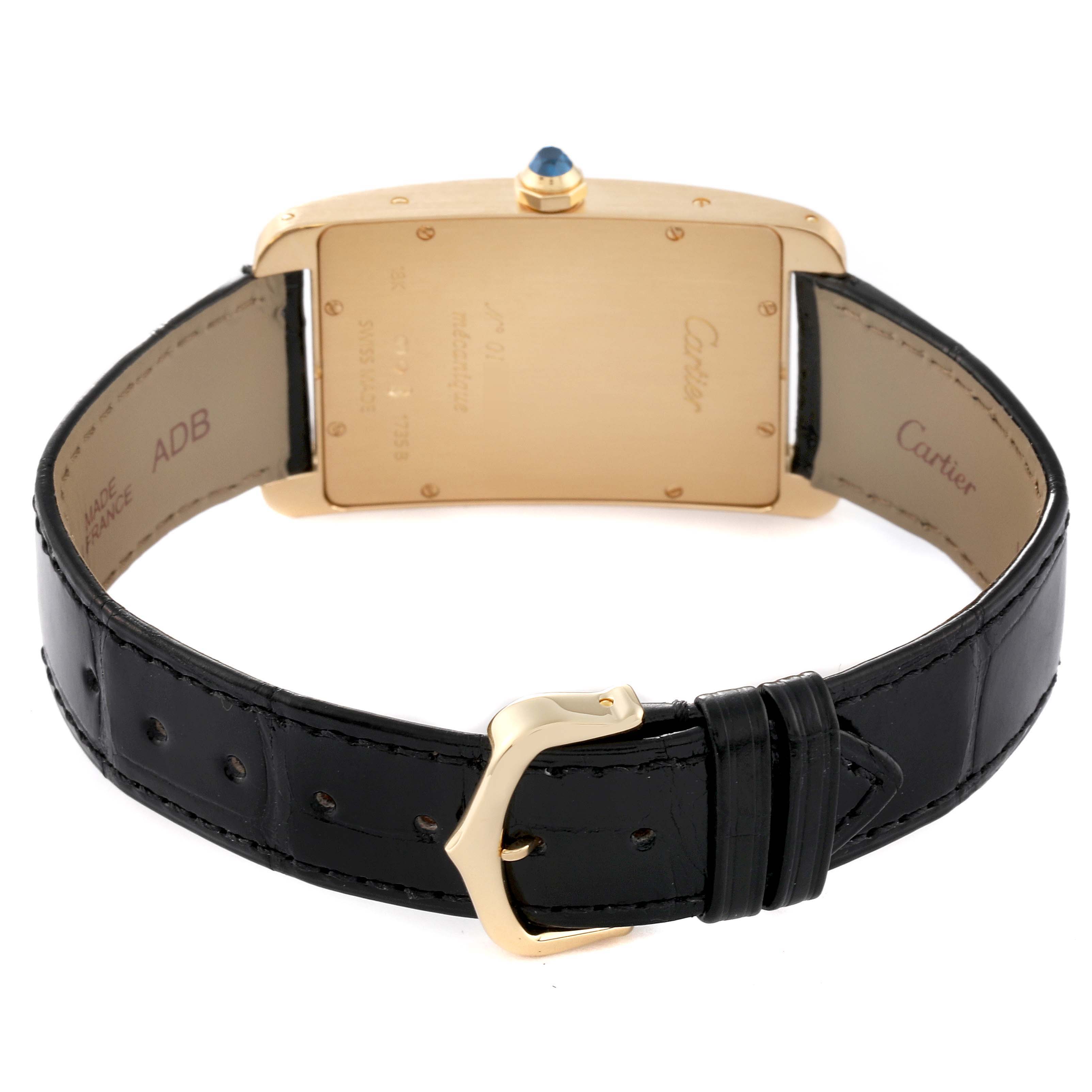 This image shows the back view of a Cartier Tank Americaine 1735 Men's Yellow Gold Silver Dial 1735 Men's Yellow Gold Silver Dial watch, highlighting the strap and buckle.