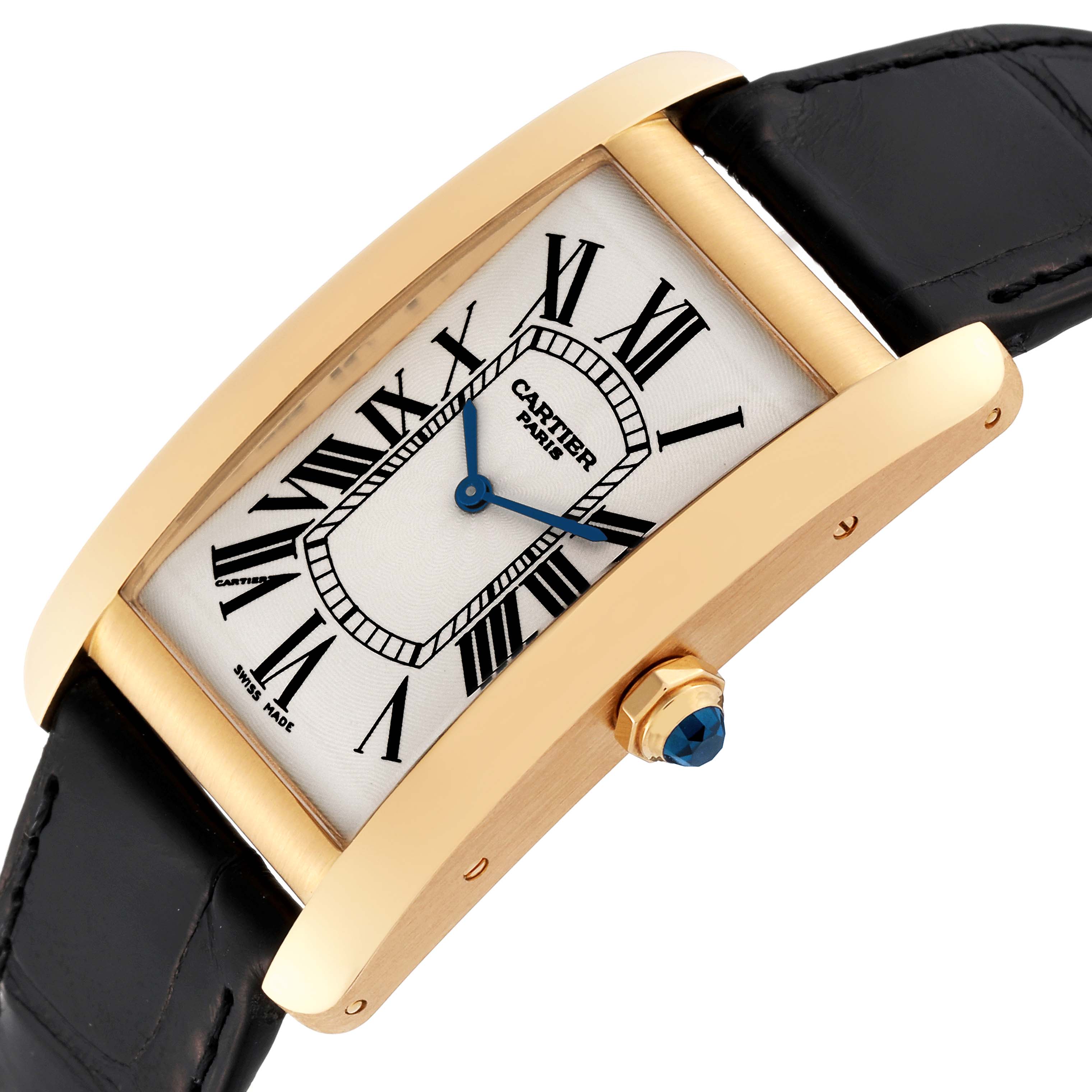 The Cartier Tank Americaine 1735 Men's Yellow Gold Silver Dial 1735 Men's Yellow Gold Silver Dial watch is shown at a slight angle, highlighting its rectangular face, Roman numerals, and black leather strap.