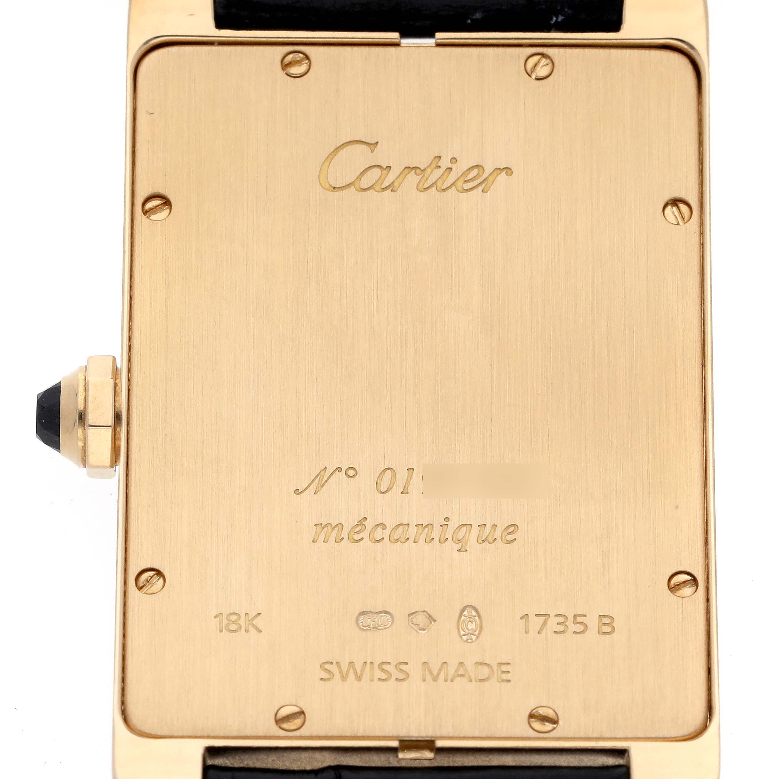 The image shows the back case of a Cartier Tank Americaine 1735 Men's Yellow Gold Silver Dial 1735 Men's Yellow Gold Silver Dial watch, featuring engravings and the winding crown.