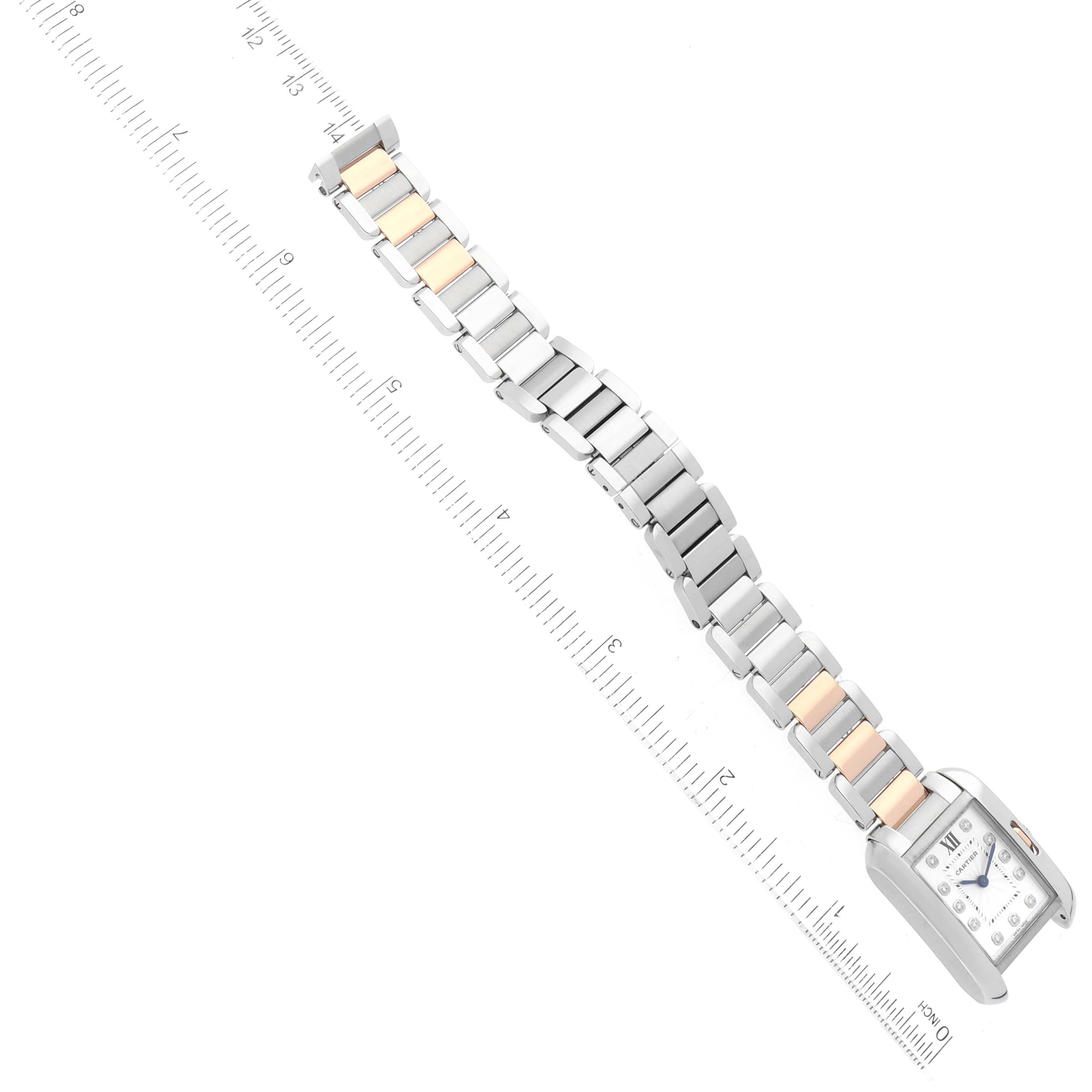 The Cartier Tank Anglaise WT100024 Women
s Steel and Gold (two tone) Silver Dial WT100024 Women
s Steel and Gold (two tone) Silver Dial watch is shown from an aerial view, highlighting the face and bracelet with a ruler for reference.