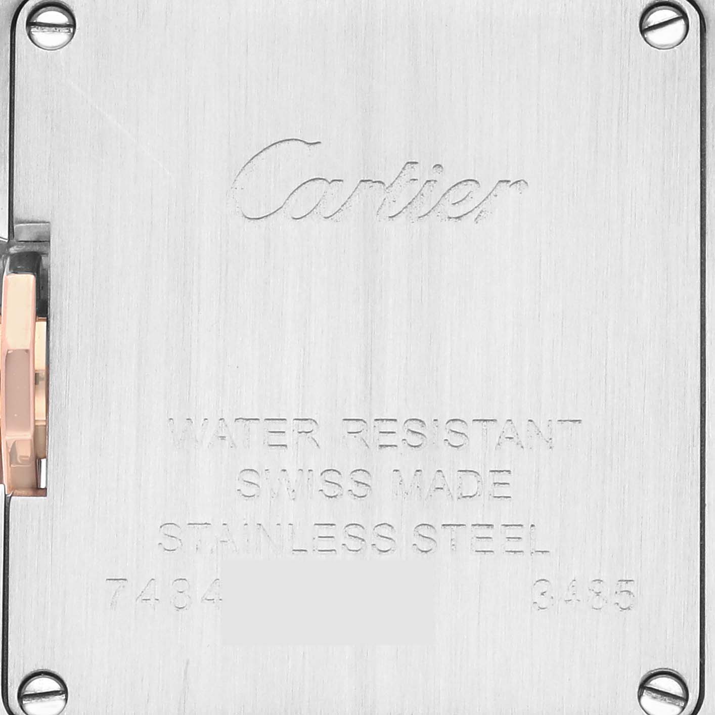 This image shows the back case of a Cartier Tank Anglaise WT100024 Women
s Steel and Gold (two tone) Silver Dial WT100024 Women
s Steel and Gold (two tone) Silver Dial watch, highlighting the engraved brand name and specifications.