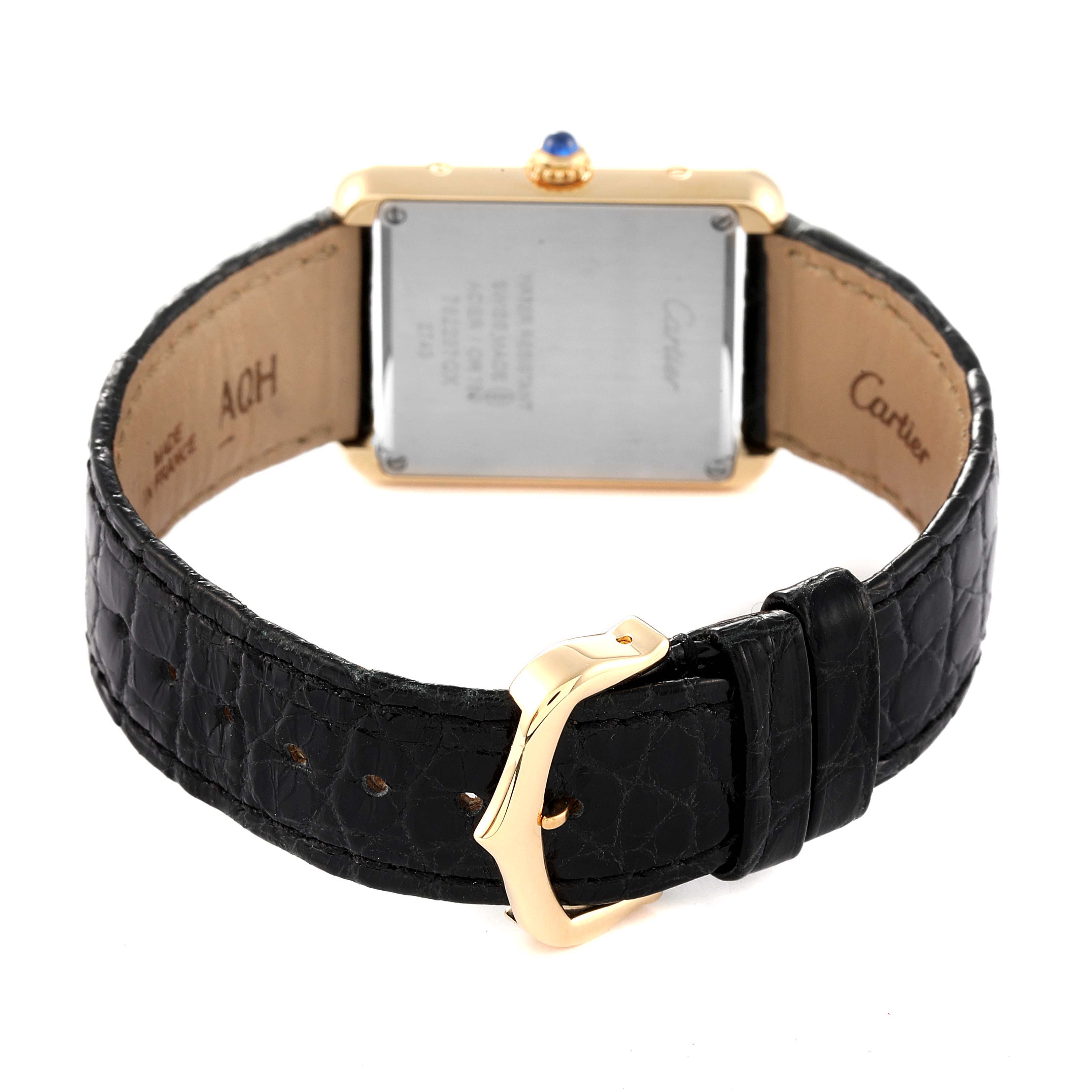 The image shows the back view of a Cartier Tank Solo W1018755 Women's Yellow Gold Silver Dial W1018755 Women's Yellow Gold Silver Dial watch, including its rectangular case, leather strap, and buckle.