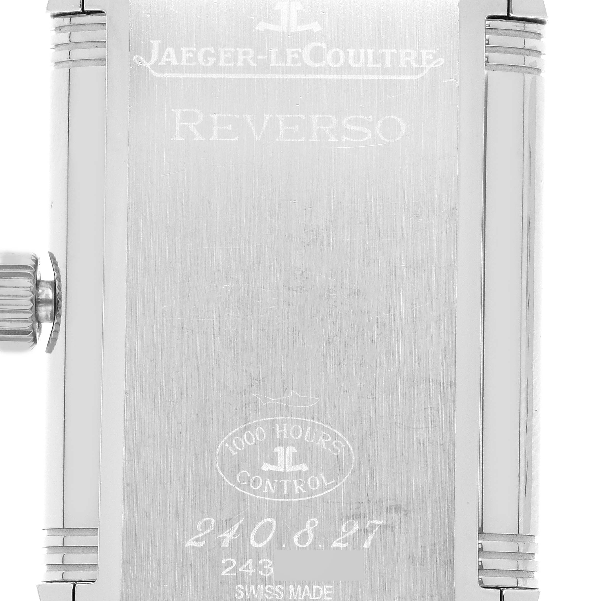 The image shows the back of the Jaeger-LeCoultre Reverso watch, prominently featuring its engraving and crown.