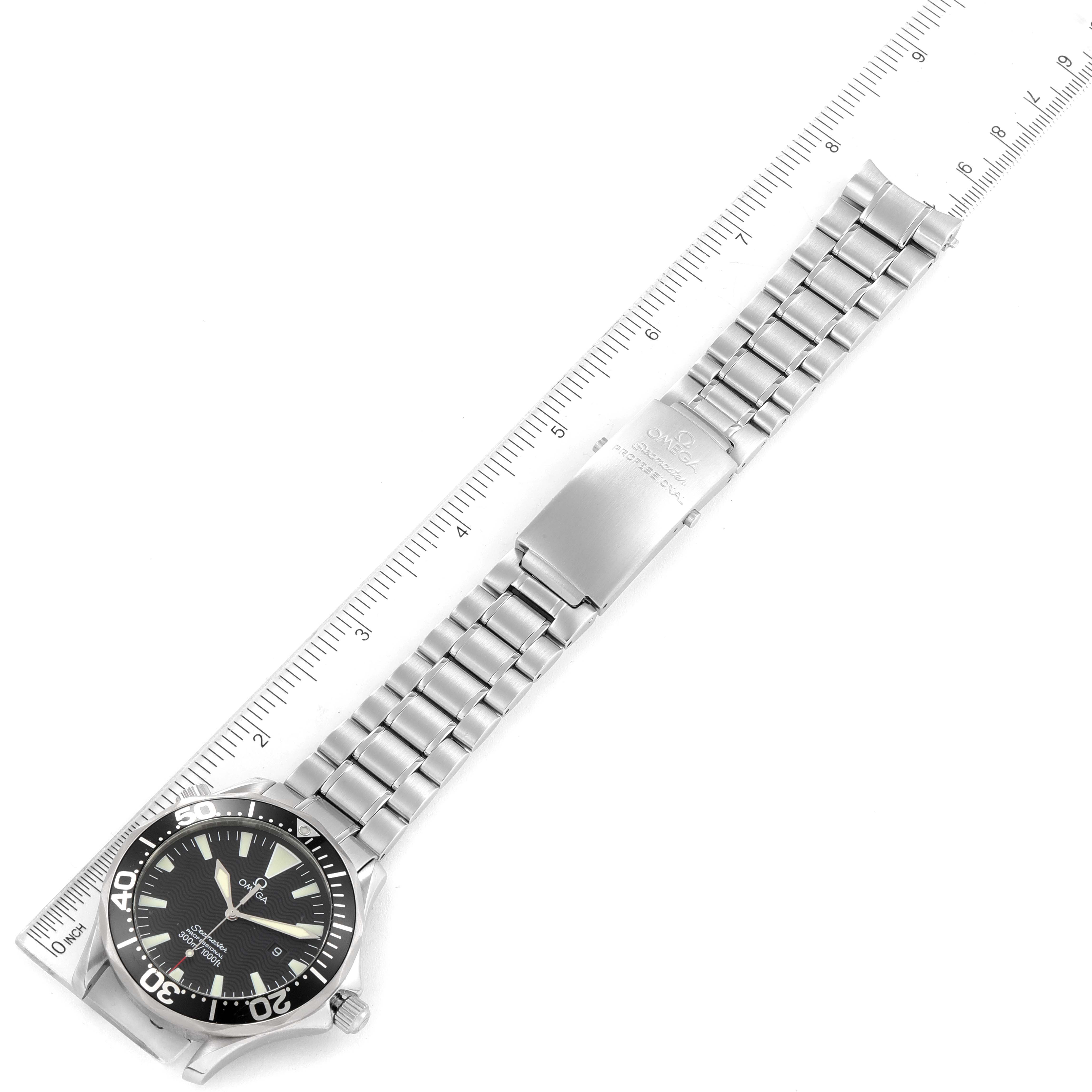 The image shows an Omega Seamaster 2264.50.00 Men's Stainless Steel Black Dial 2264.50.00 Men's Stainless Steel Black Dial watch placed flat with its stainless steel bracelet fully extended alongside a ruler.