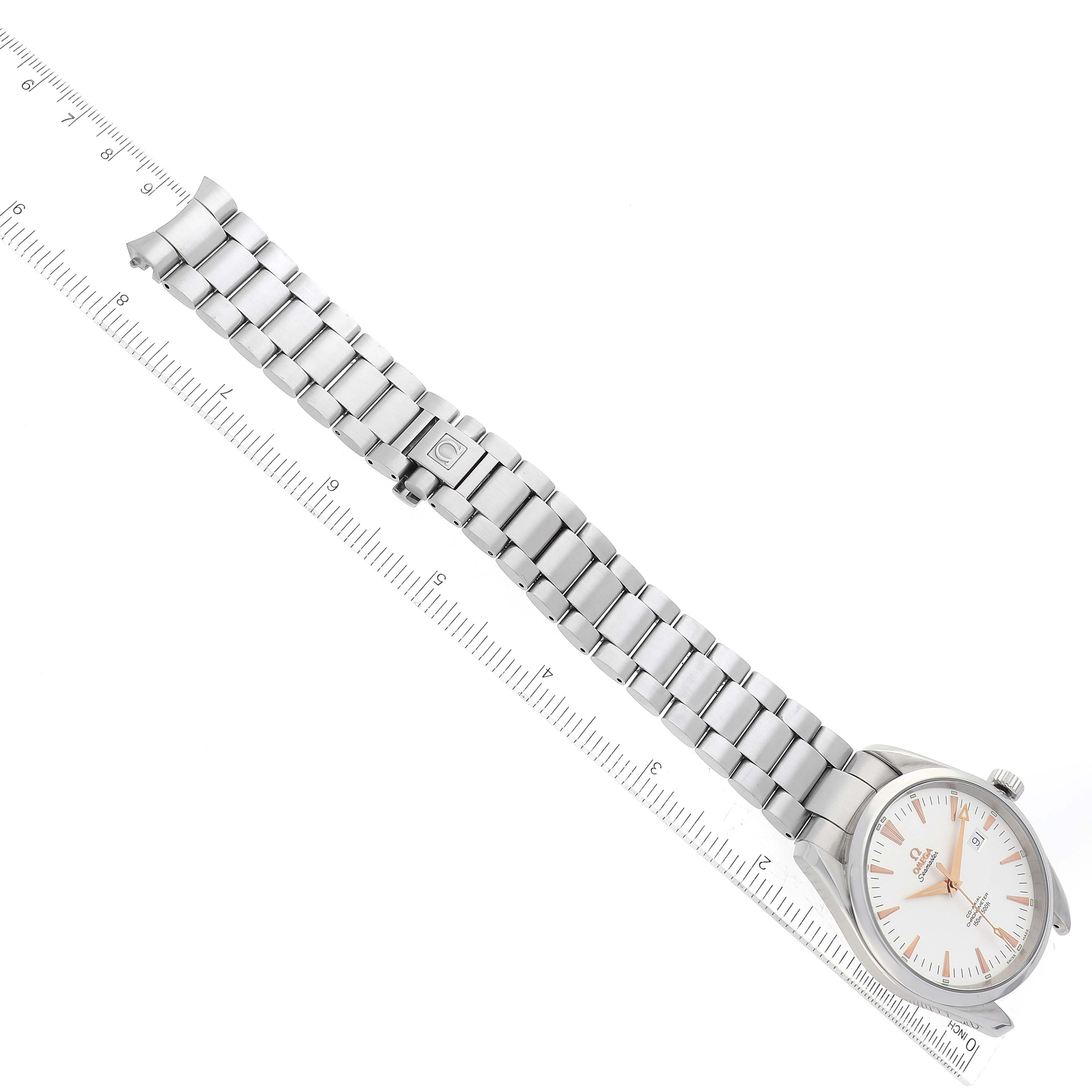 The image shows an Omega Aqua Terra 2502.34.00 Men's Stainless Steel Silver Dial 2502.34.00 Men's Stainless Steel Silver Dial watch from an overhead angle, highlighting its bracelet and face next to a ruler for scale.
