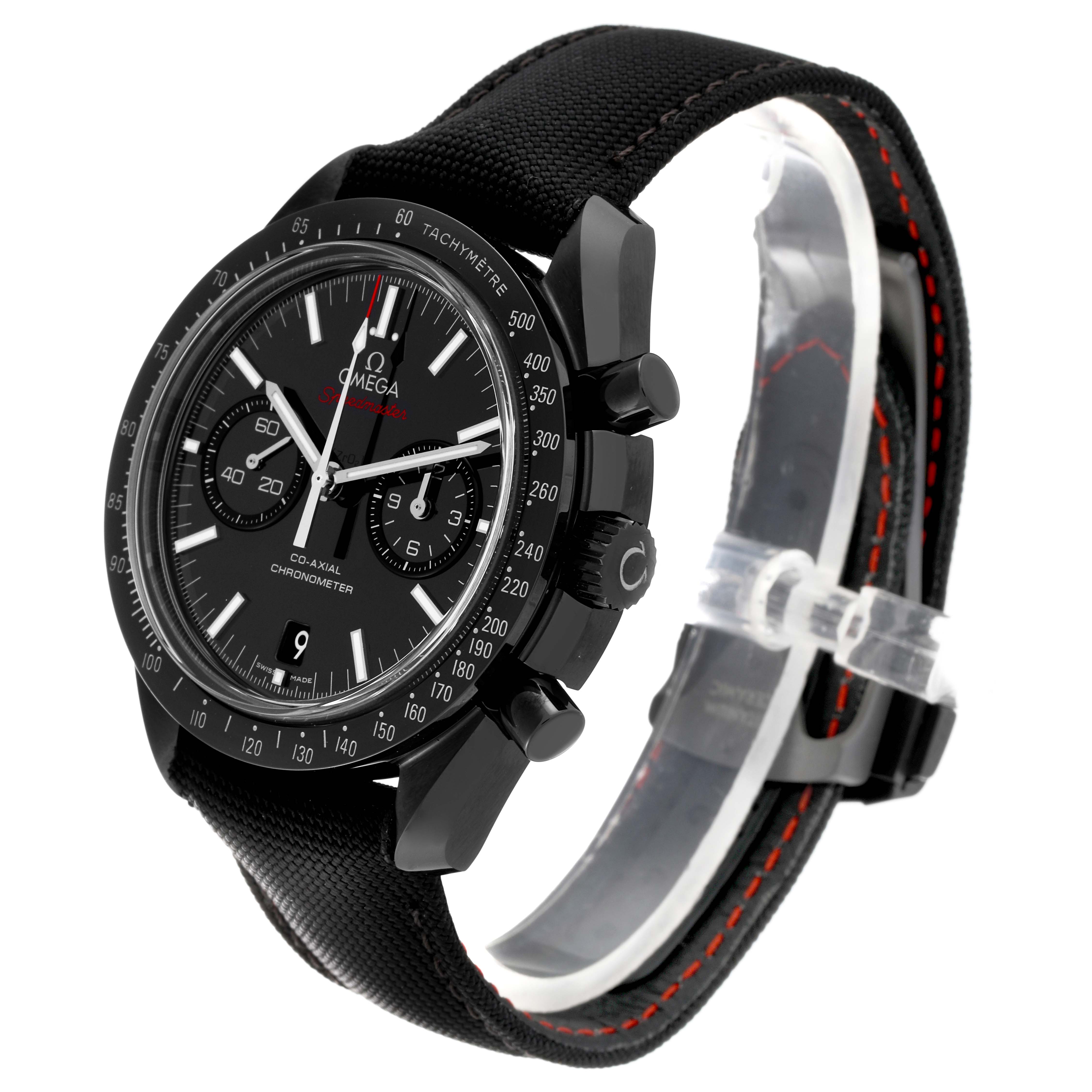 The image shows a side angle of an Omega Speedmaster 311.92.44.51.01.003 Men's Ceramic Black Dial 311.92.44.51.01.003 Men's Ceramic Black Dial watch featuring its black dial, bezel, chronograph subdials, and strap with red stitching.