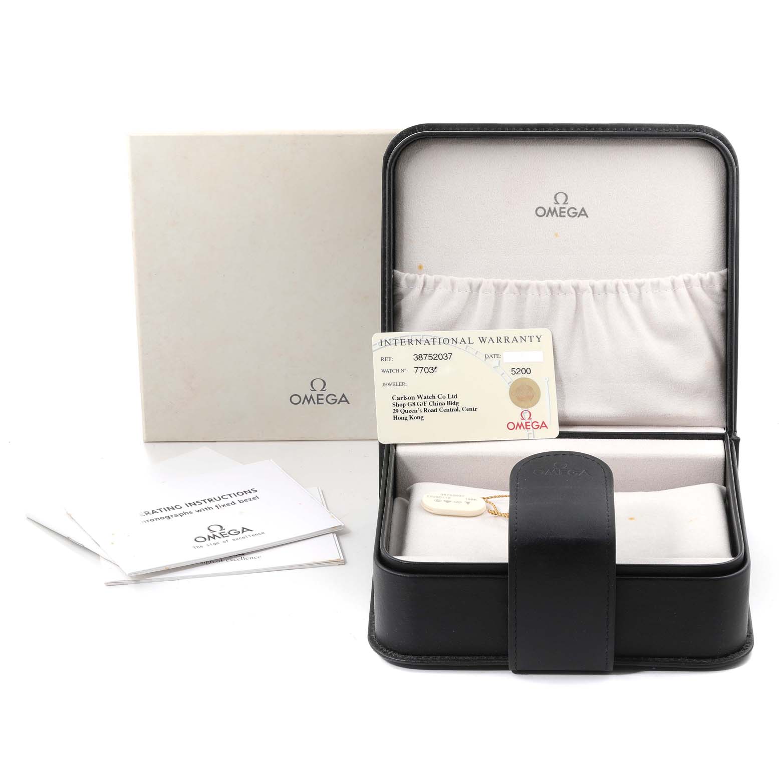 The image shows an Omega Speedmaster 3875.20.37 Men's Stainless Steel White Dial 3875.20.37 Men's Stainless Steel White Dial watch box, international warranty card, outer box, and operating instructions.