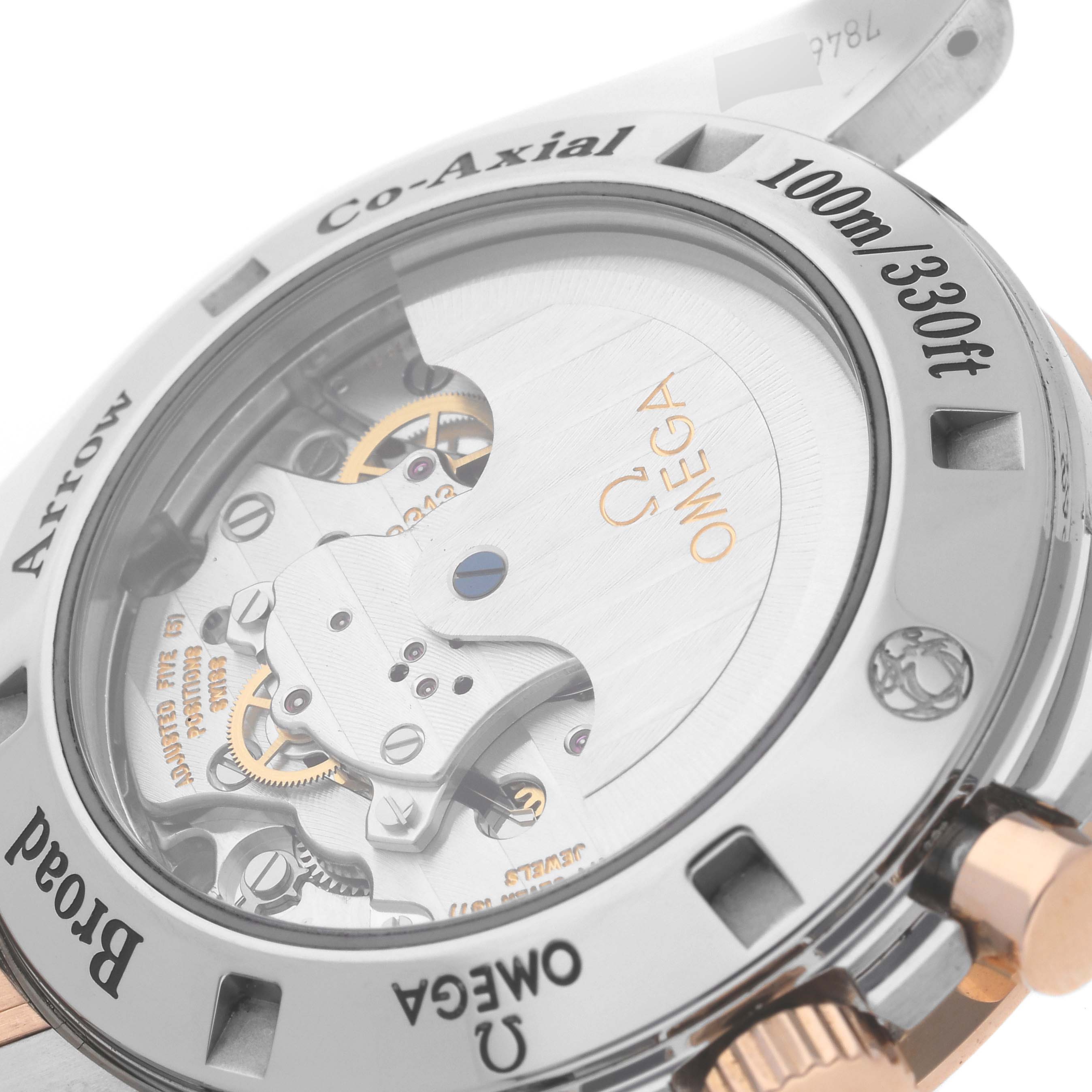 The image shows the back of an Omega Speedmaster 321.90.42.50.13.001 Men's Steel and Gold (two tone) Brown Dial 321.90.42.50.13.001 Men's Steel and Gold (two tone) Brown Dial watch, highlighting the Co-Axial movement and water resistance rating.