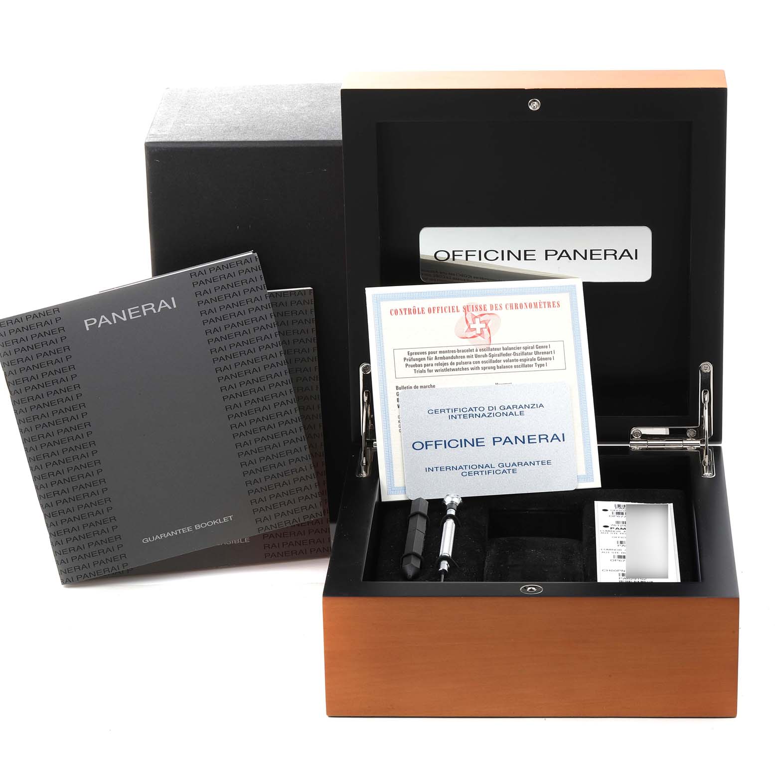 The image shows an open Panerai Submersible PAM00024 Men's Stainless Steel Black Dial PAM00024 Men's Stainless Steel Black Dial watch box with documentation, booklets, tools, and the international guarantee certificate.