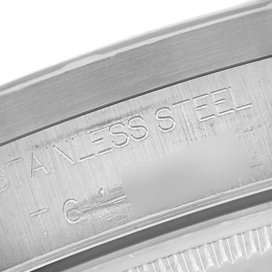 This image shows a close-up of the bezel and part of the inscription on a Rolex Air-King 14010 Men's Stainless Steel Silver Dial 14010 Men's Stainless Steel Silver Dial stainless steel watch.
