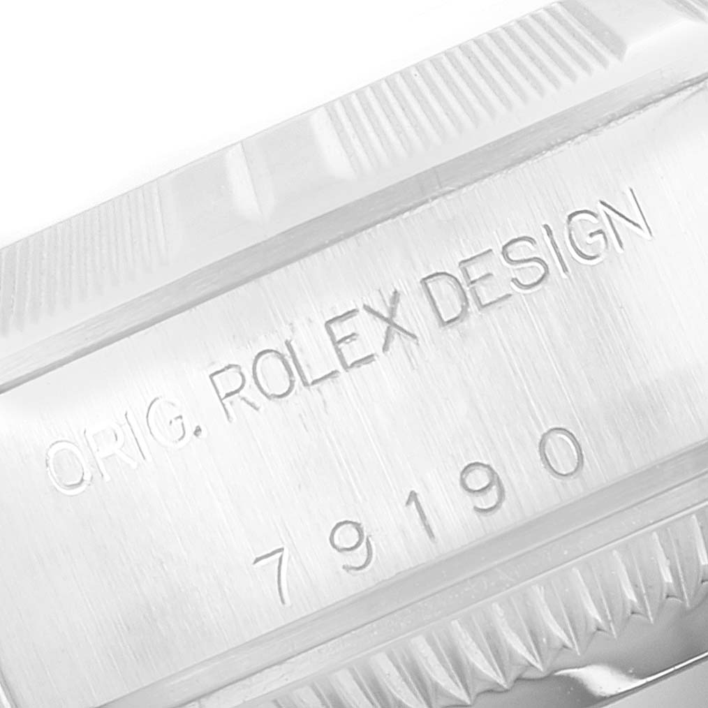 This image shows a close-up of the side engraving on a Rolex Date 79190 Women's Stainless Steel White Dial 79190 Women's Stainless Steel White Dial, highlighting "ORIG. ROLEX DESIGN" and the model number 79190.