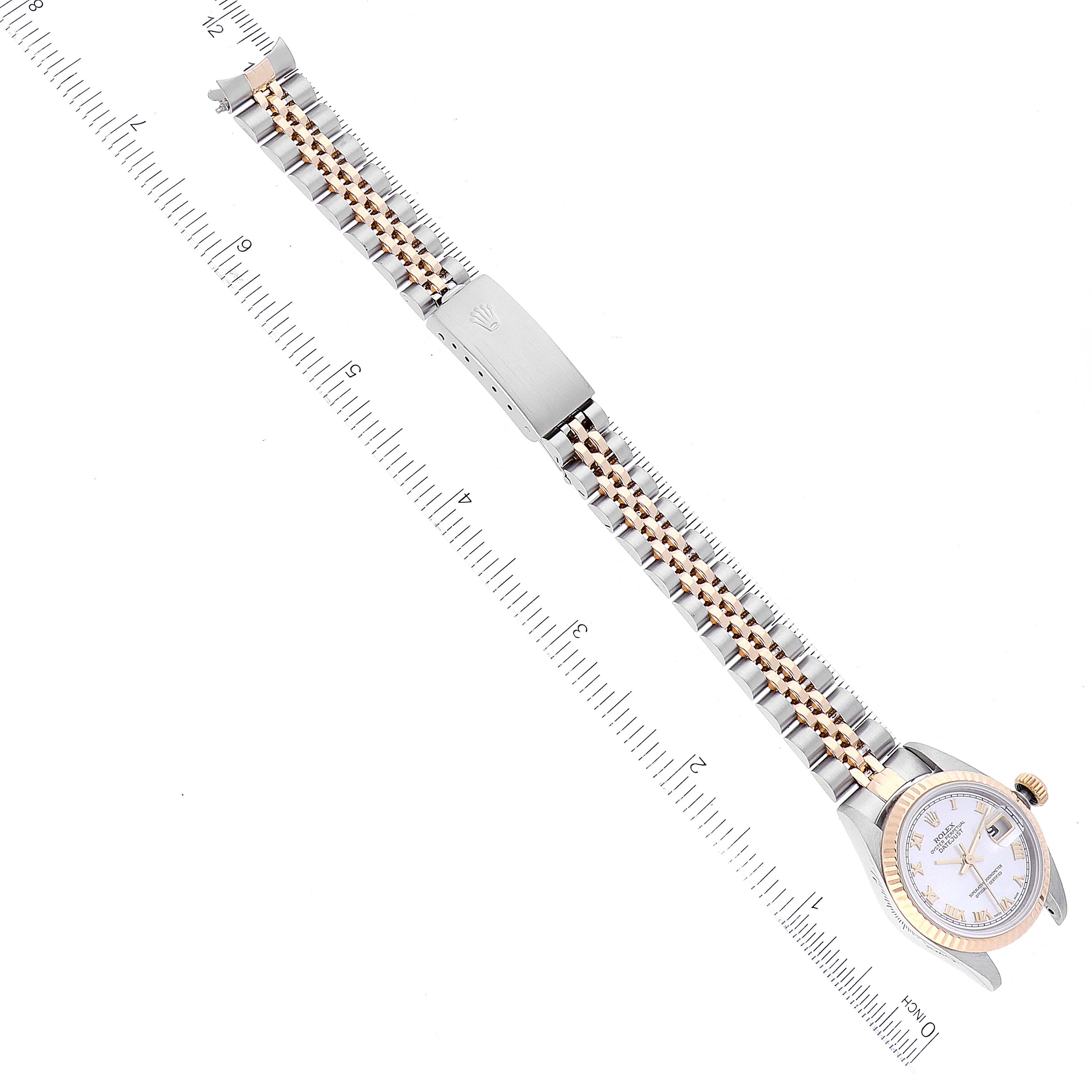 The image shows a Rolex Datejust 79173 Women's Steel and Gold (two tone) Mother of Pearl Dial 79173 Women's Steel and Gold (two tone) Mother of Pearl Dial watch with its strap laid flat next to a measuring scale, captured from a top-down angle.