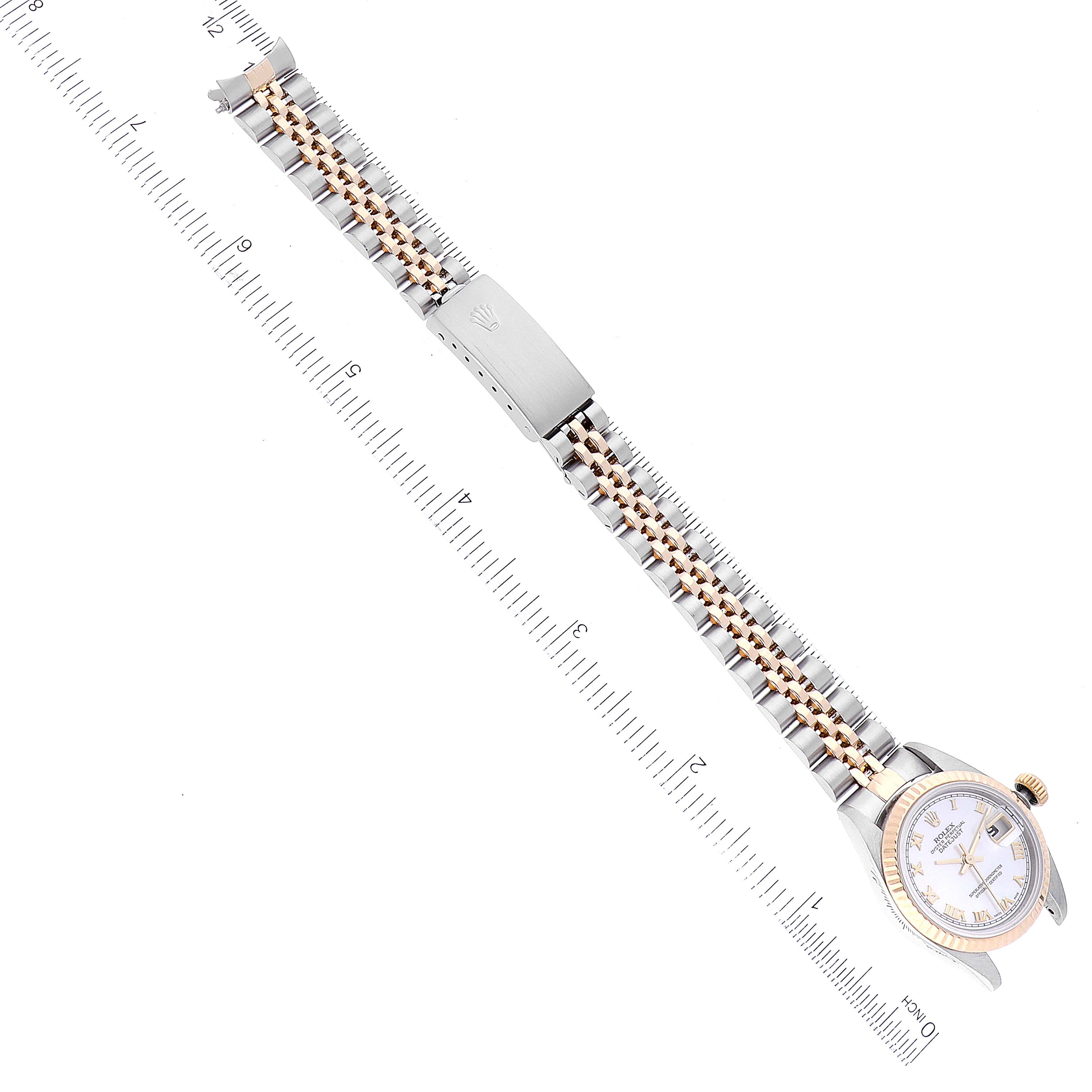 This image shows a Rolex Datejust 79173 Women's Steel and Gold (two tone) Mother of Pearl Dial 79173 Women's Steel and Gold (two tone) Mother of Pearl Dial watch from a top-down angle, featuring the watch face, bracelet, and clasp.