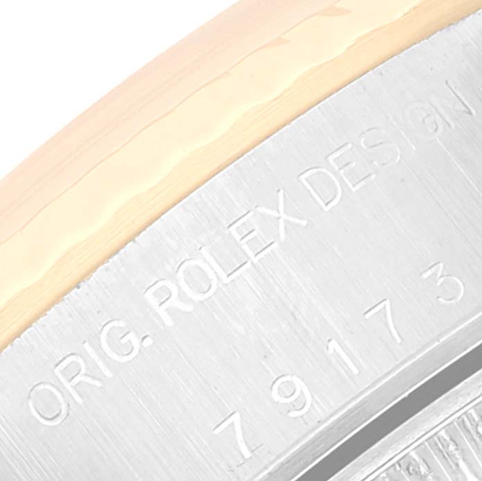 The image shows a close-up of the side of the bezel and reference number engraving on the Rolex Datejust 79173 Women's Steel and Gold (two tone) Mother of Pearl Dial 79173 Women's Steel and Gold (two tone) Mother of Pearl Dial model.