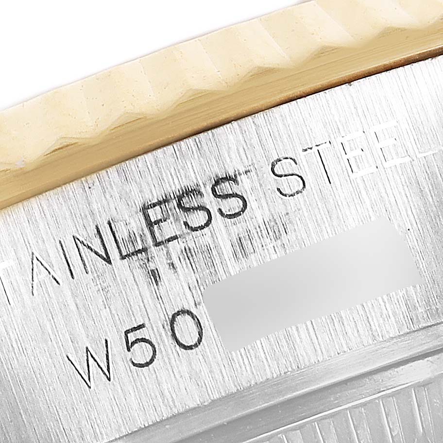 Close-up angle showing the fluted bezel and stainless steel part of the Rolex Datejust 69173 Women's Steel and Gold (two tone) Blue Dial 69173 Women's Steel and Gold (two tone) Blue Dial model.