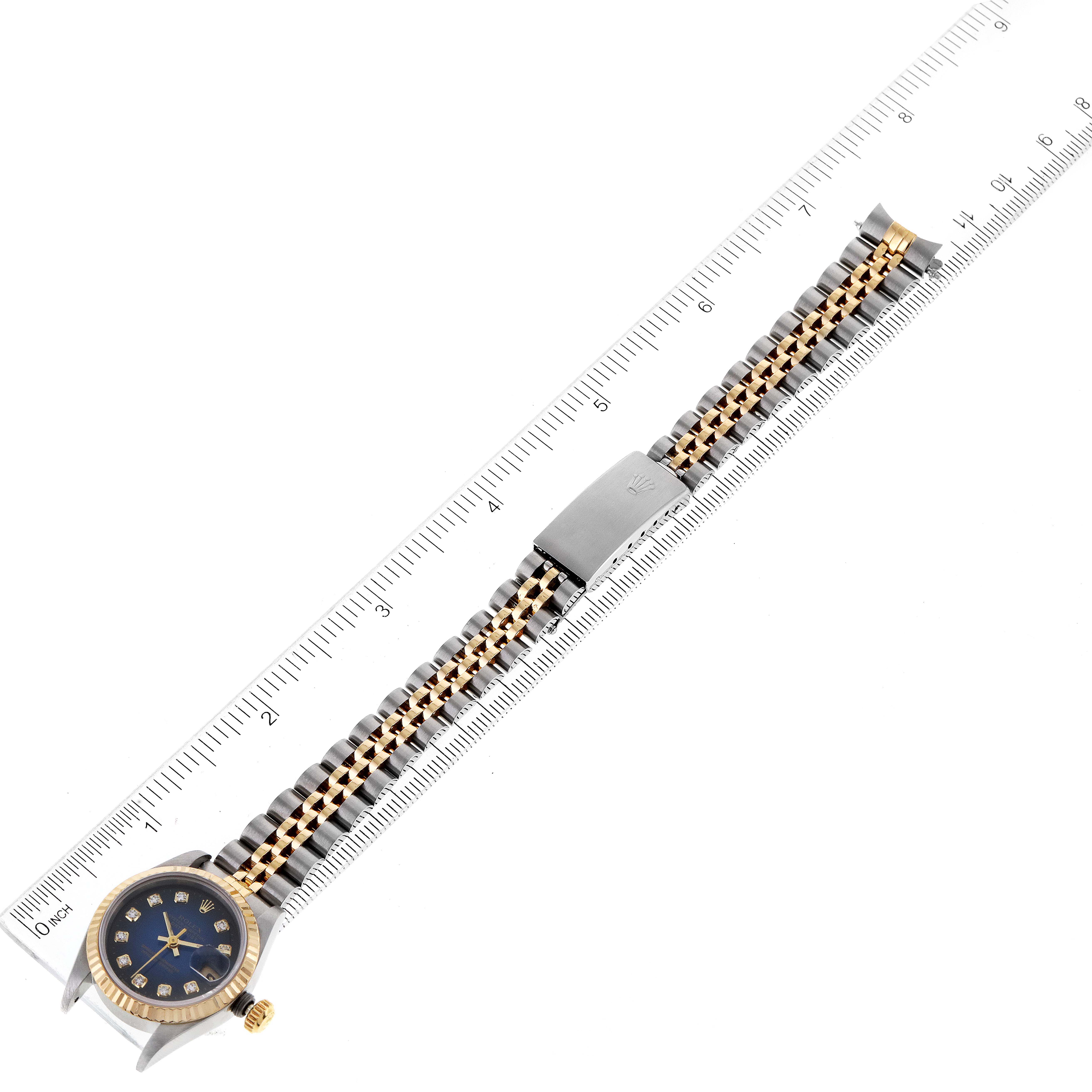 The image shows a Rolex Datejust 69173 Women's Steel and Gold (two tone) Blue Dial 69173 Women's Steel and Gold (two tone) Blue Dial watch laid flat, measuring its length with a metallic ruler.