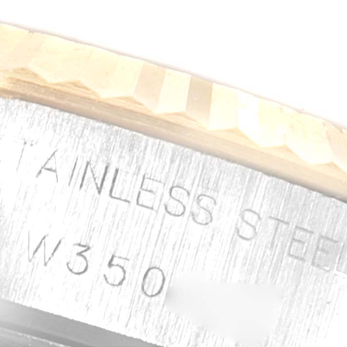 This image shows a close-up of the side of a Rolex Datejust 69173 Women
s Steel and Gold (two tone) Champagne Dial 69173 Women
s Steel and Gold (two tone) Champagne Dial watch, highlighting the stainless steel part with partial inscriptions.