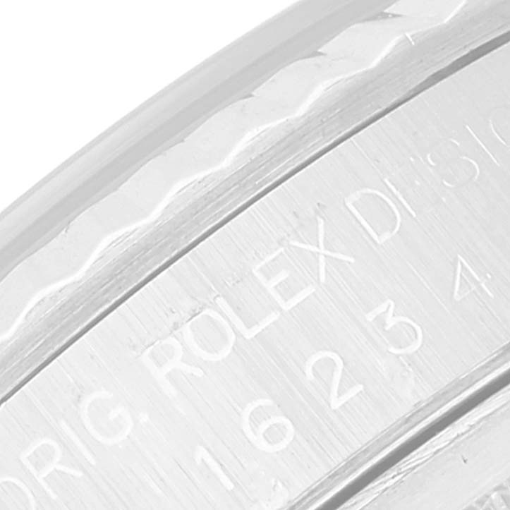 Close-up of the engraved text on the case or bezel of a Rolex Datejust 16234 Men's Stainless Steel Blue Dial 16234 Men's Stainless Steel Blue Dial watch.