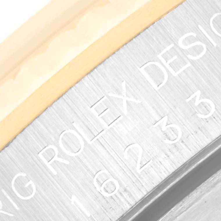 This is a close-up of the side engravings on the casing of a Rolex Datejust 16233 Men's Steel and Gold (two tone) Black Dial 16233 Men's Steel and Gold (two tone) Black Dial watch.