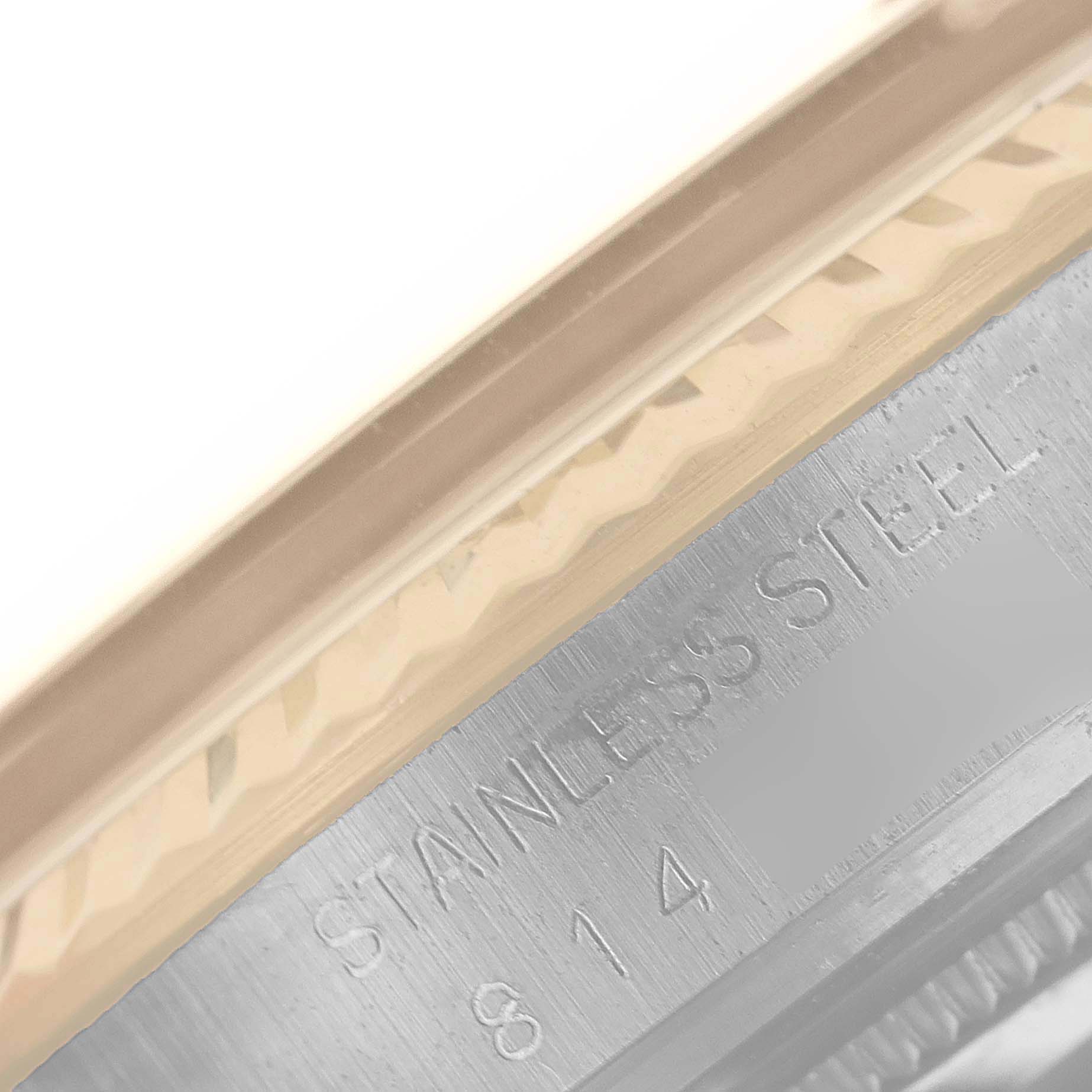 The image shows a close-up of the side of the casing of a Rolex Vintage Collection 16013 Men's Steel and Gold (two tone) Champagne Dial 16013 Men's Steel and Gold (two tone) Champagne Dial watch, highlighting the stainless steel engraving.