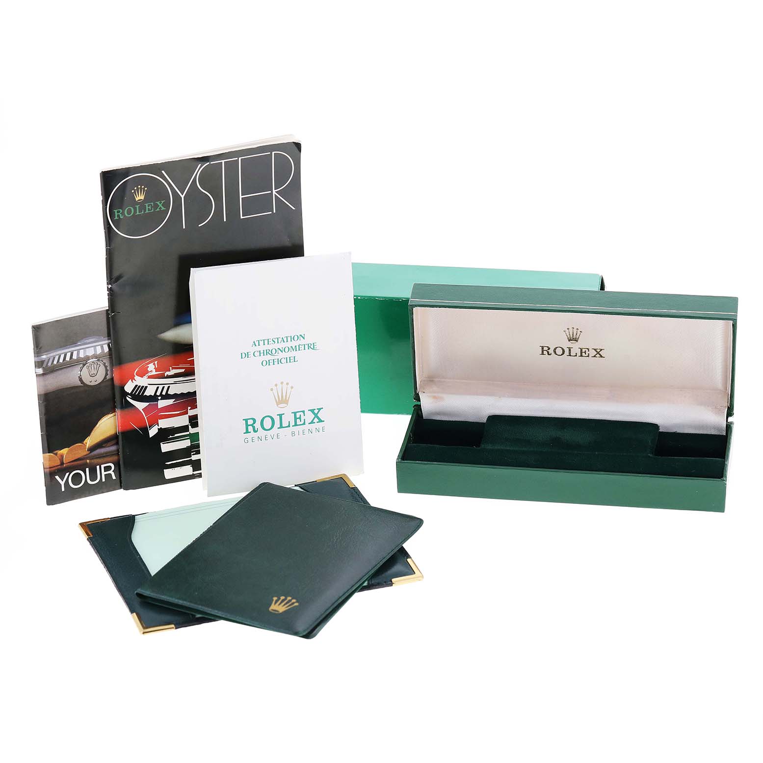 The image shows the packaging, manuals, and accessories of a Vintage Collection model by Rolex, with the watch box prominently displayed.