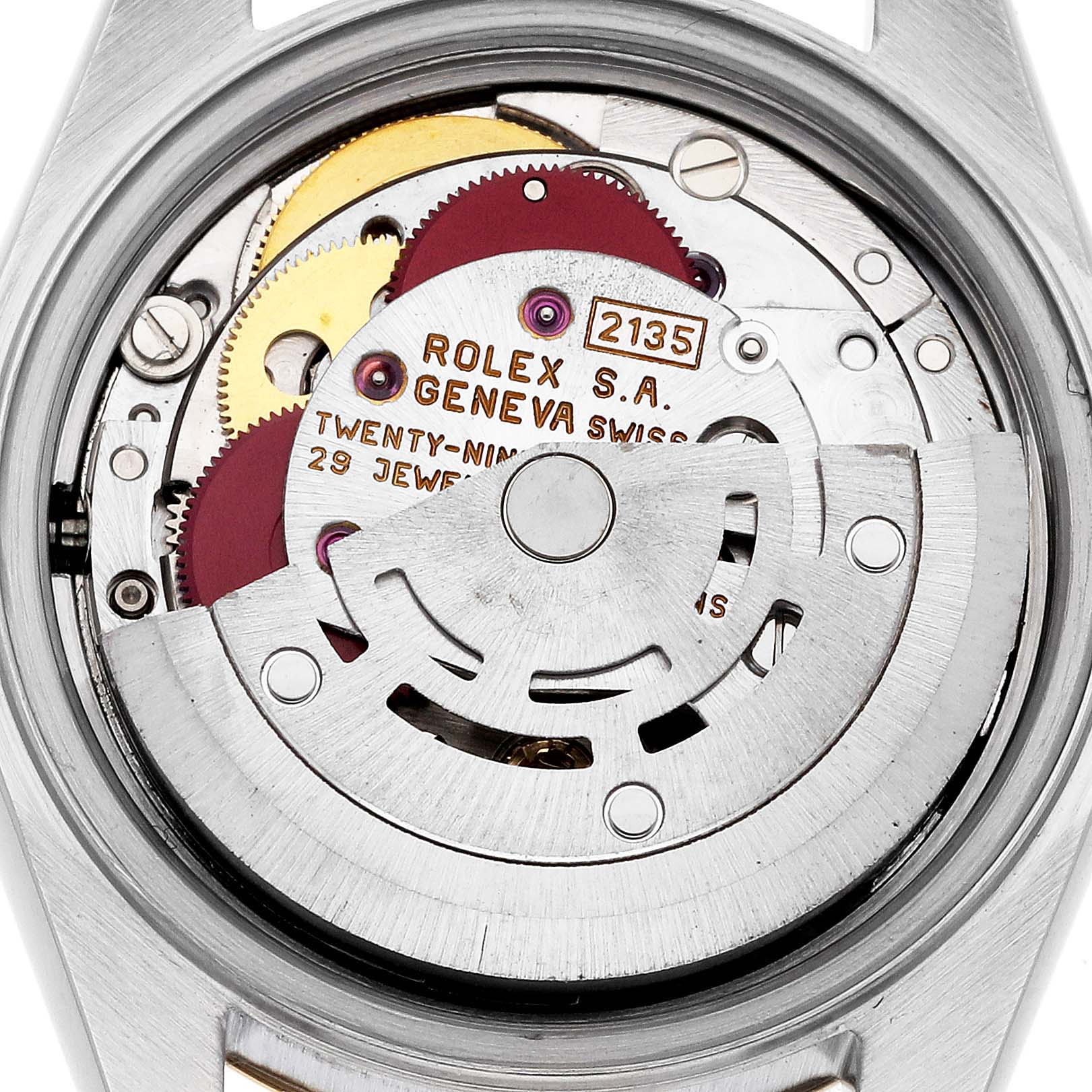 The image shows the internal mechanism of a Rolex Datejust 69173G Women's Steel and Gold (two tone) Black Dial 69173G Women's Steel and Gold (two tone) Black Dial watch, including gears and the movement components from a back angle.