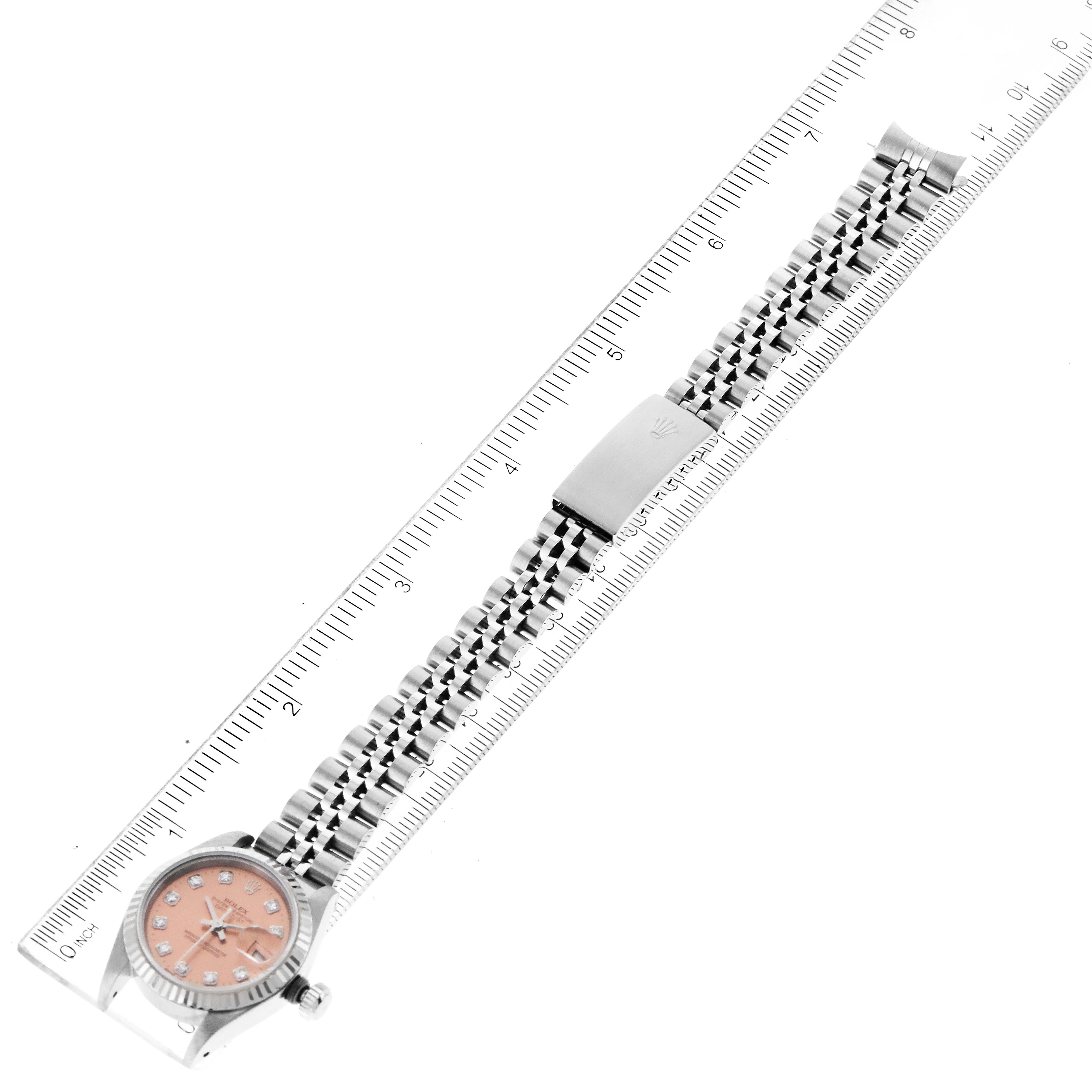 The image shows the Rolex Datejust 69174 Women's Stainless Steel Pink Dial 69174 Women's Stainless Steel Pink Dial watch laid flat with the bracelet and clasp visible, placed next to a ruler for scale reference.