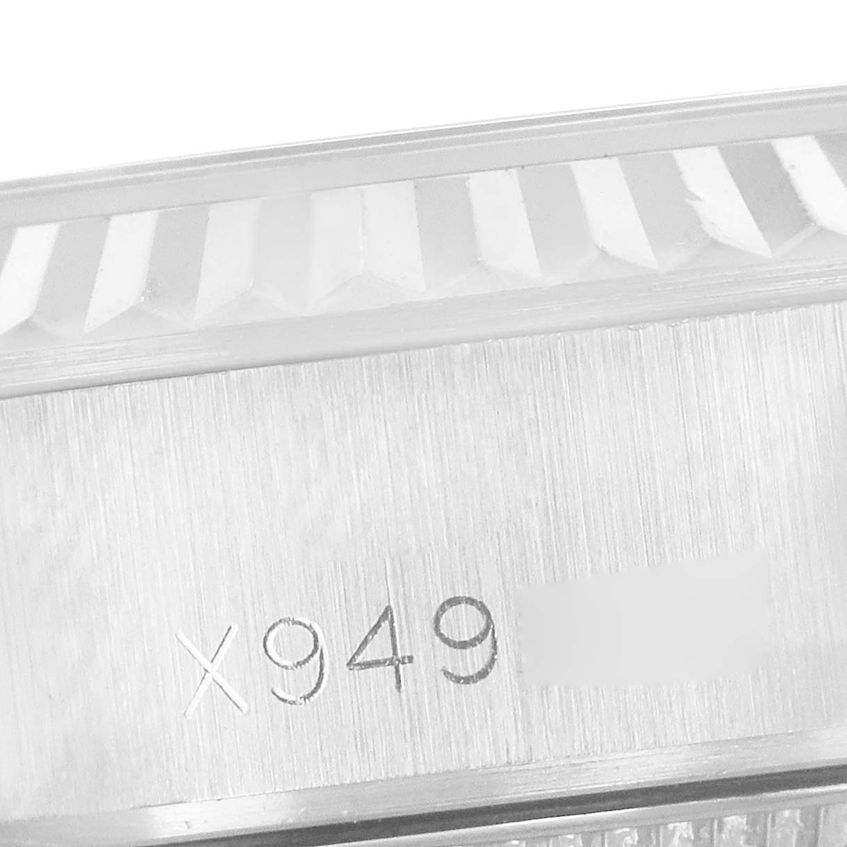 The image shows the engraved serial number on the side of the bezel and case of a Rolex Datejust 69174 Women's Stainless Steel Pink Dial 69174 Women's Stainless Steel Pink Dial watch.