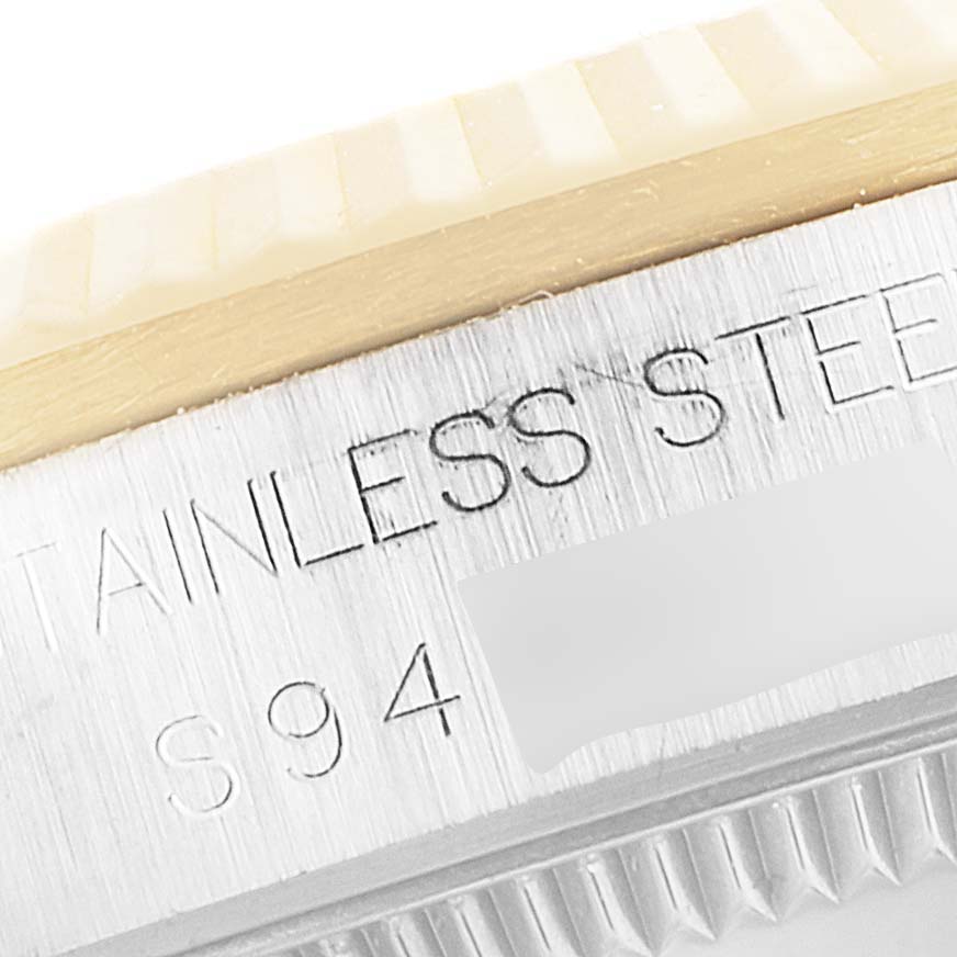 This close-up image shows the stainless steel bezel and a portion of the fluted edge of the Rolex Mid-Size 68273 Women's Steel and Gold (two tone) Champagne Dial 68273 Women's Steel and Gold (two tone) Champagne Dial model.