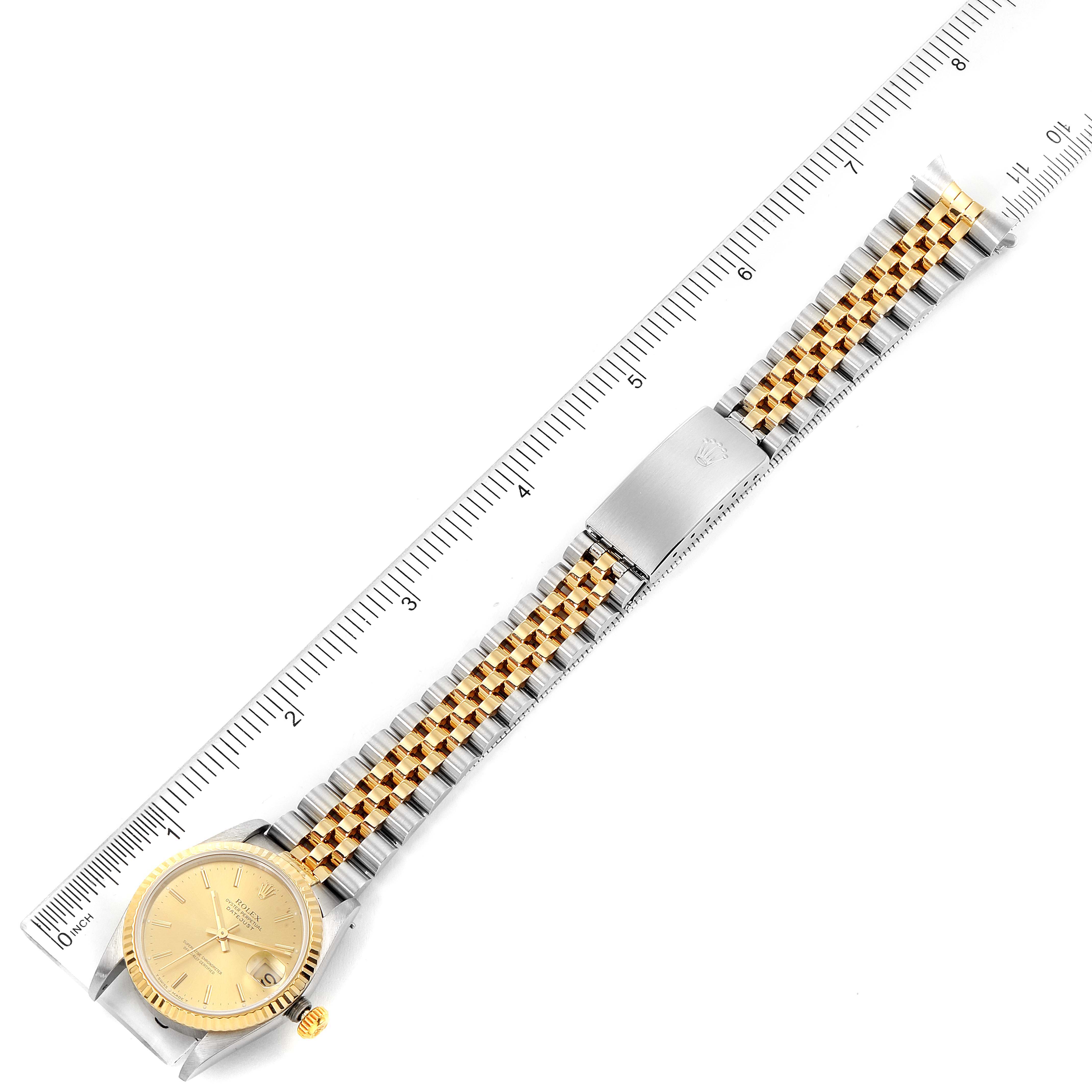 The image shows a top view of a Mid-Size Rolex watch with a two-tone bracelet and a ruler for scale.