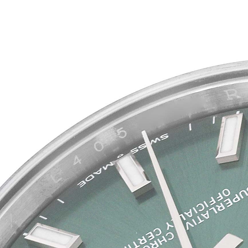 This image shows a close-up of the dial and bezel of a Mid-Size Rolex watch.