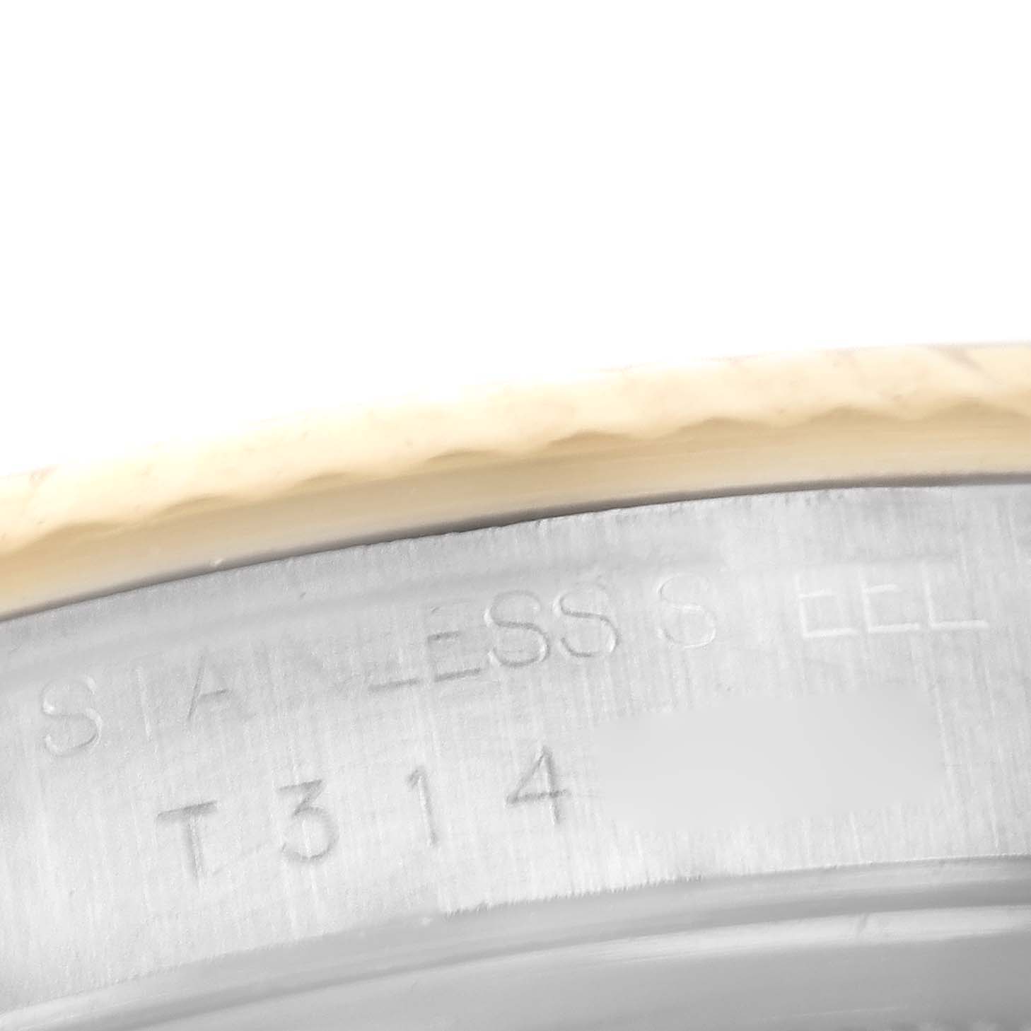 This image shows a close-up view of the stainless steel part of a Rolex Datejust 16233 Men's Steel and Gold (two tone) Champagne Dial 16233 Men's Steel and Gold (two tone) Champagne Dial watch, highlighting its engraving.